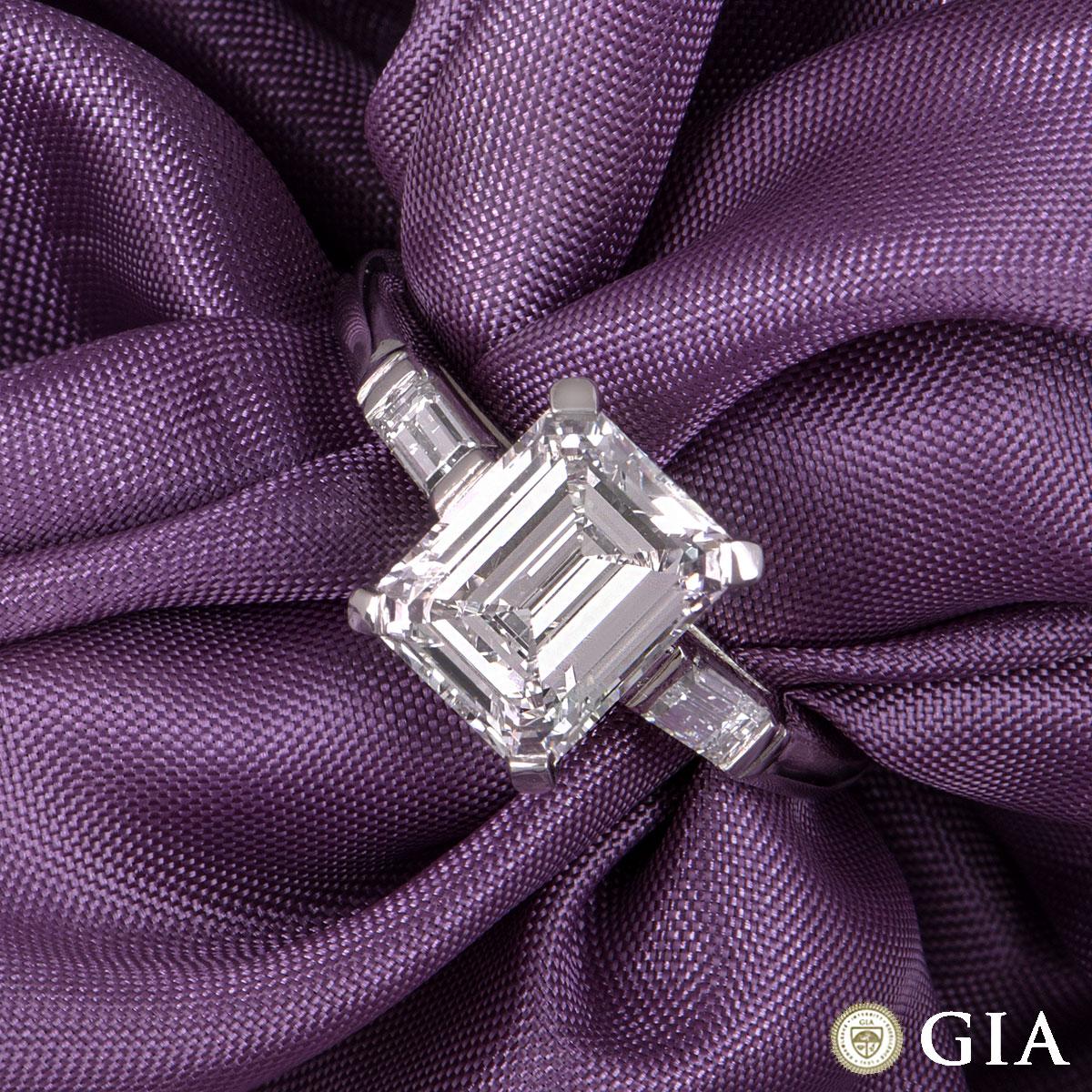 A stunning platinum emerald cut diamond ring. The ring comprises of an emerald cut diamond in the centre within a four claw setting with a weight of 1.92ct, F in colour and VVS2 clarity. The diamond is complemented by one baguette cut diamond on