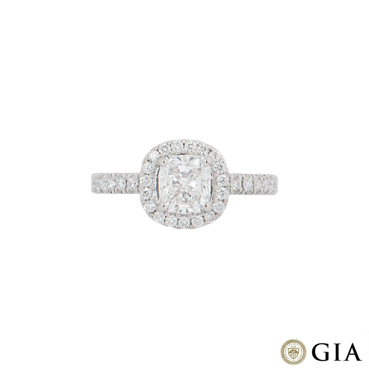 A stunning platinum cushion cut diamond engagement ring. The ring comprises of a cushion cut diamond in a halo setting with a weight of 1.00ct, H in colour and VS1 clarity. The round brilliant diamonds in the halo setting have a total weight of