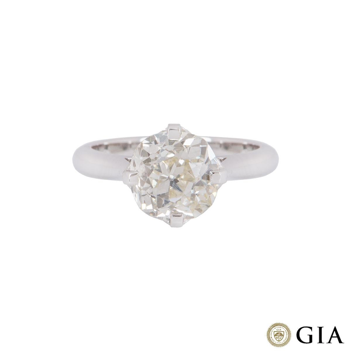 A stunning platinum old mine cut diamond ring. The ring is set to the centre with a 2.71ct old mine brilliant cut diamond of which is U to V range in colour and VS2 clarity. The diamond is set within a bespoke platinum 4 claw setting featuring pave