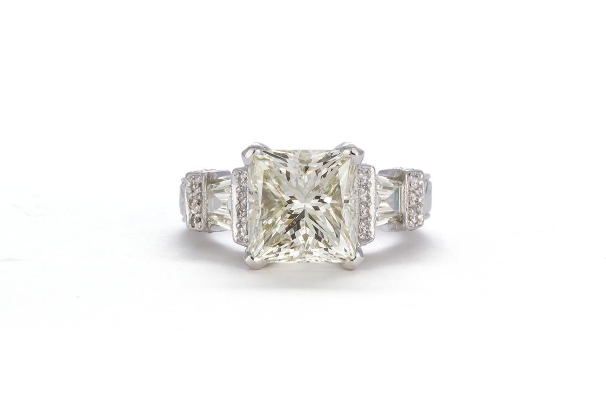 We are pleased to offer this GIA Certified Platinum & Princess Cut Diamond Engagement Ring. This beautiful ring features a GIA certified 5.30ct L/SI2 princess cut diamond accented by two trapezoid cut diamonds and four rows of round brilliant cut