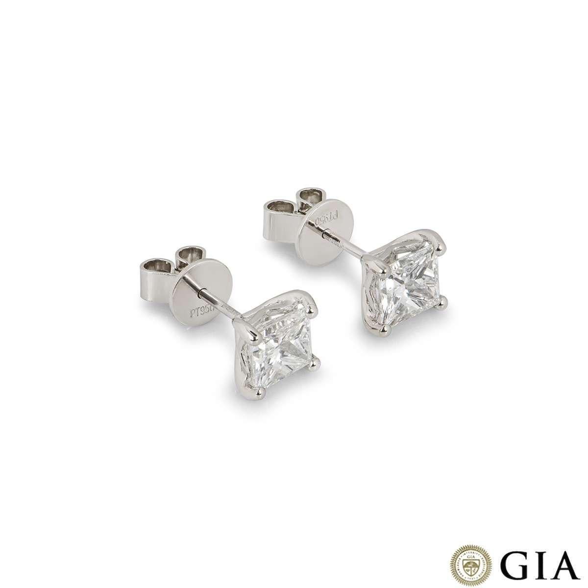 A stunning pair of platinum diamond earrings. Each earring has a princess cut diamond in a classic 4 claw setting. Each diamond weighs 1.20ct, one diamond is G colour and the other is F colour, both diamonds are VS1 clarity. The earrings feature