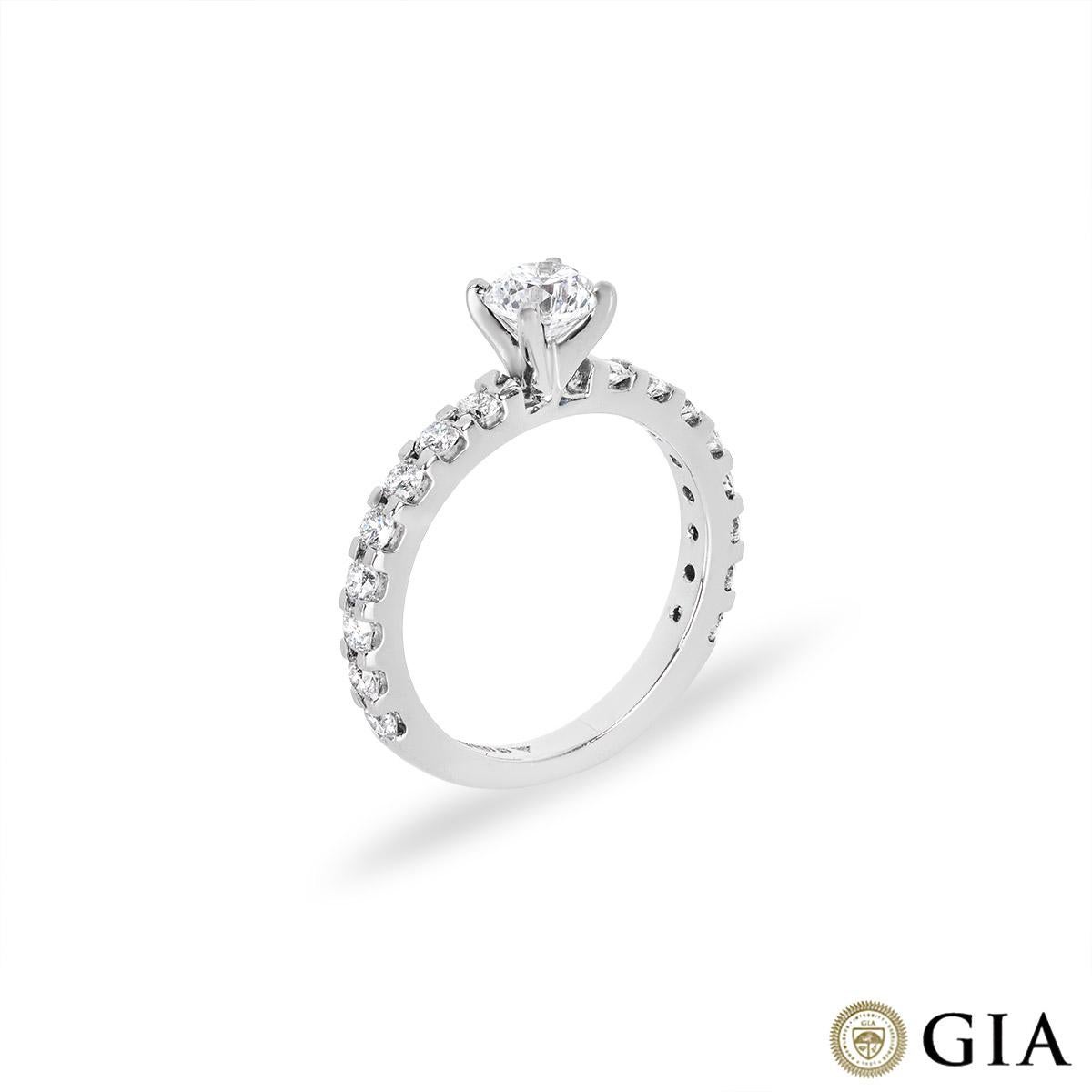 A classic platinum diamond engagement ring. The ring is set to the centre with a round brilliant cut diamond weighing 0.50ct, D colour and VS1 clarity. Accentuating the centre diamond are 16 round brilliant cut diamonds set to the shoulders with an