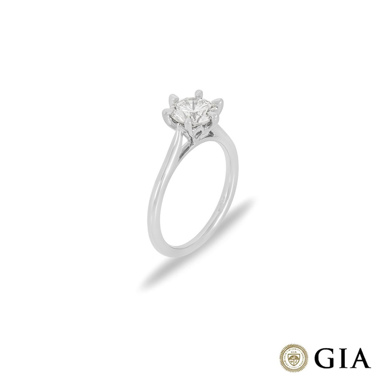 A striking platinum diamond engagement ring. The solitaire is set to the centre in a modern six prong mount with a round brilliant cut diamond weighing 1.32ct, K colour and SI2 clarity. The 1.7mm wide ring has a gross weight of 4.32 grams and is