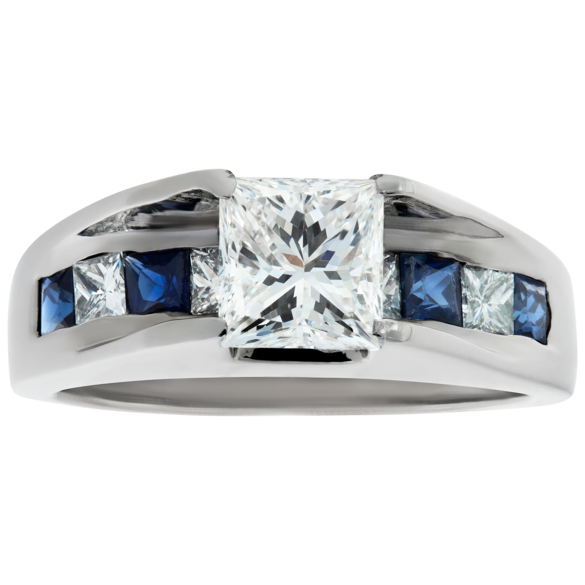 GIA certified princess cut diamond 1.01 carat (H Color, VS2 Clarity) set in platinum with side diamonds and sapphire accents. Size 5.This GIA certified ring is currently size 5 and some items can be sized up or down, please ask! It weighs 5.8