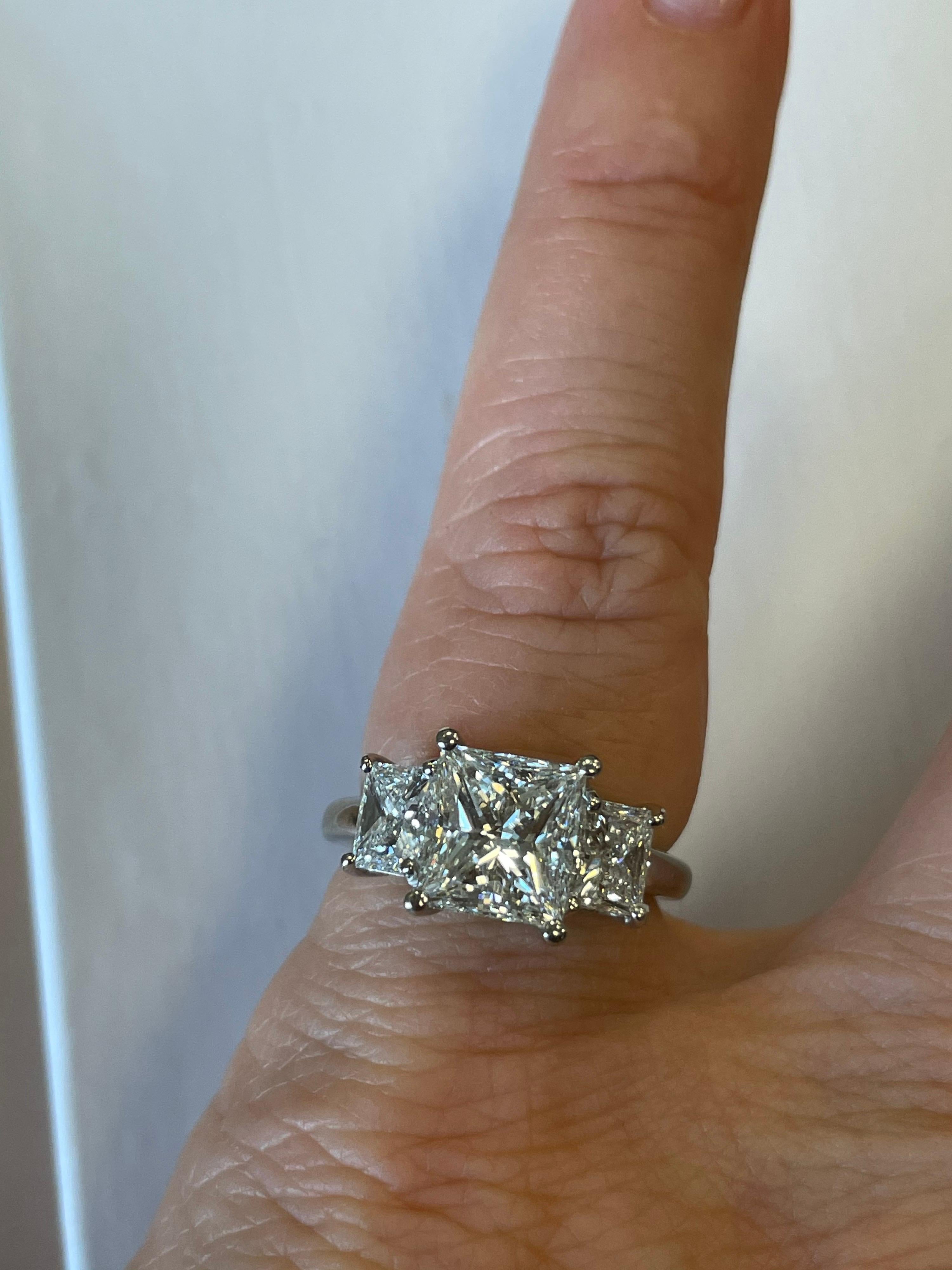GIA certified Princess cut diamond weighing 2.05cts, G color, VS1 clarity,  prong set in platinum mounting with two matching Princess cut diamonds weighing an additional 1.02cts.
Finger size 6, maybe sized
Retail $38,500