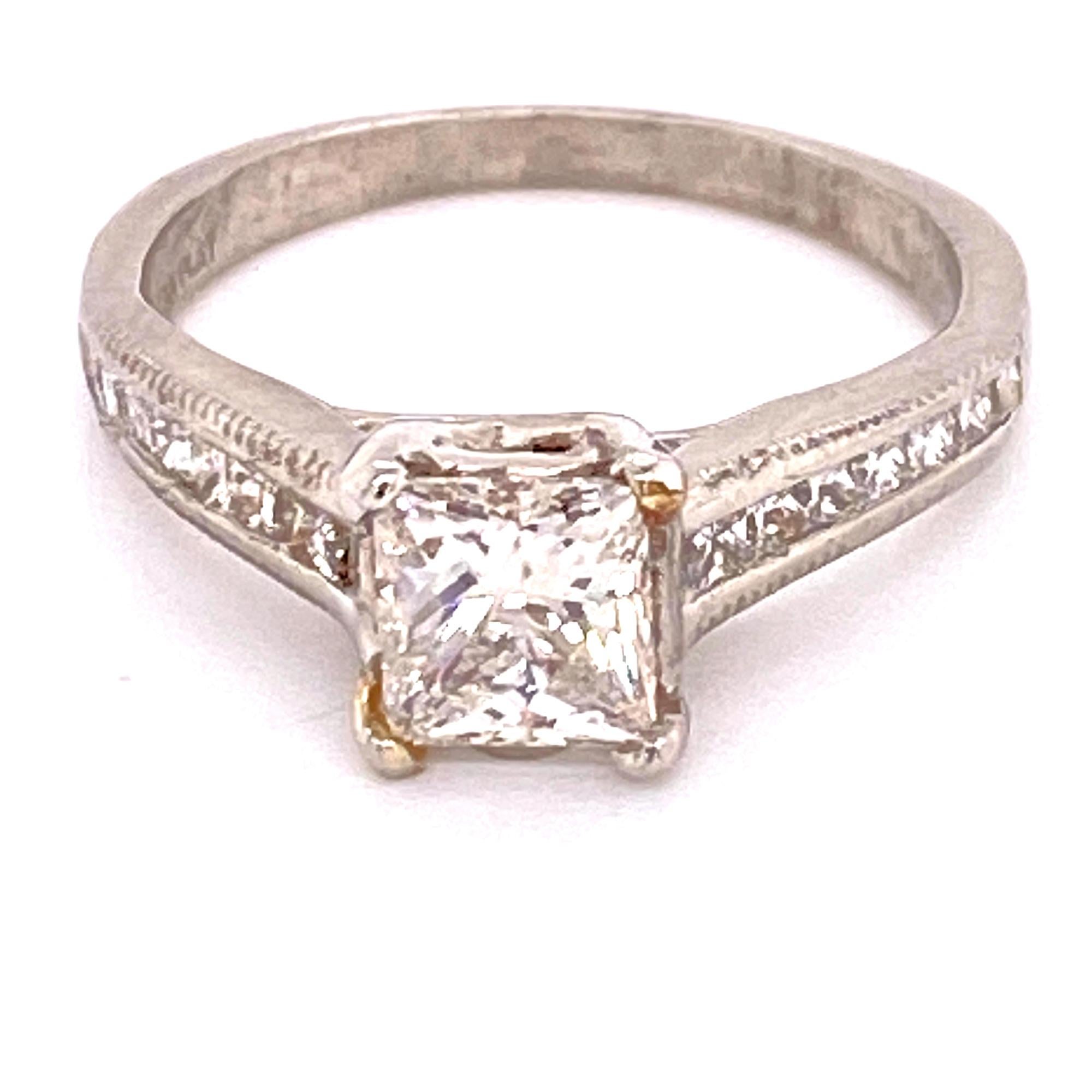 Stunning modern diamond engagement fashioned in platinum. The .72 carat princess cut diamond is GIA certified F color and SI1 clarity. The mounting features channel set princess cut diamonds weighing .33 carat total weight. The ring is currently