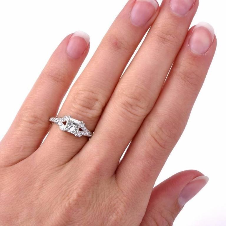 This stunning antique engagement ring is handcrafted in solid platinum.  This ring is centered with 1 genuine princess cut natural diamond vibrant approx 1.01ct, GIA certified I color, VS2 clarity with very good proportions. Adorned with some 32