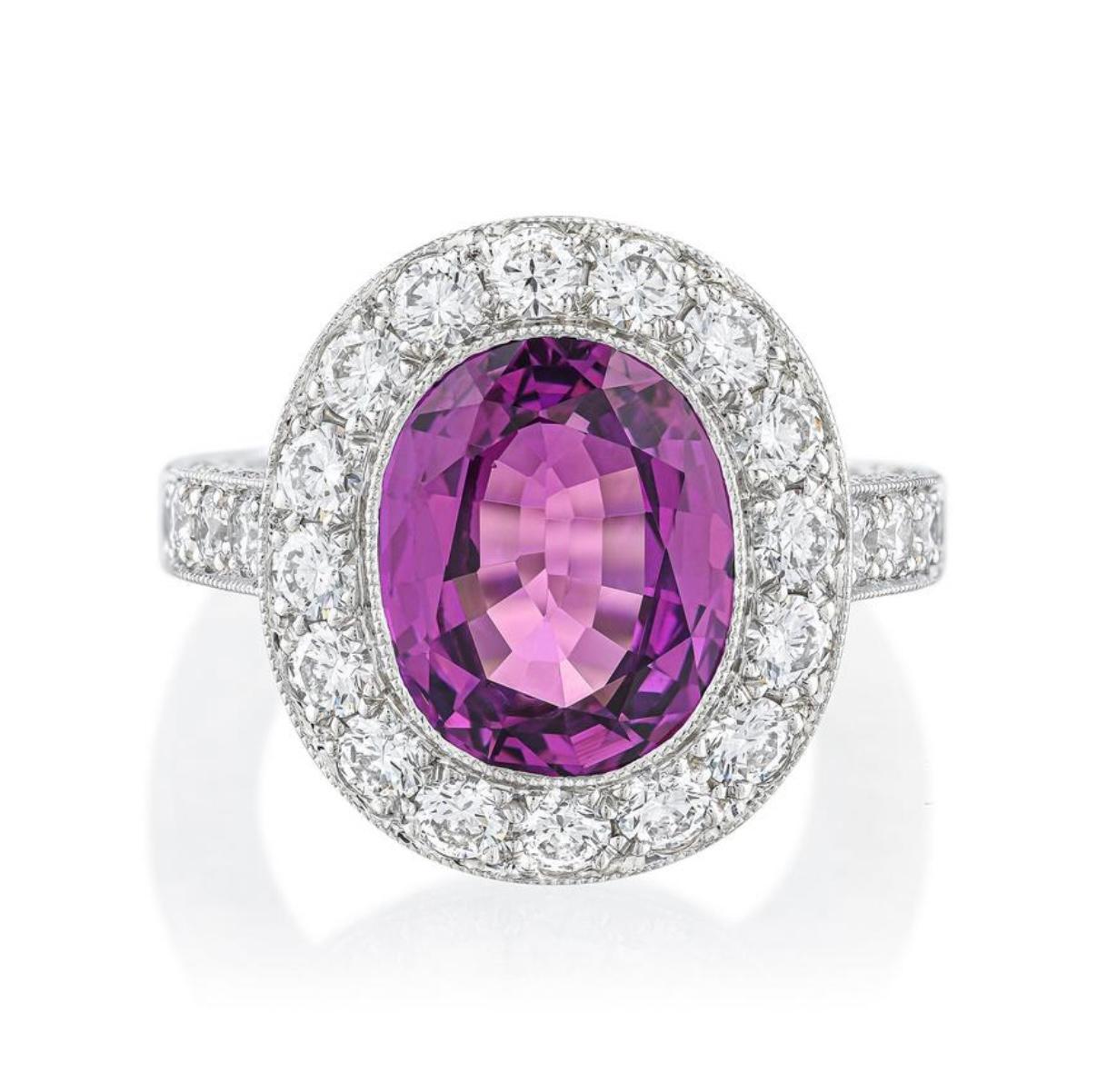 GIA certified purple sapphire and diamond ring crafted in platinum: set with an oval shape faceted purple sapphire, weighing approximately 4.50 carats: accented by round brilliant cut diamonds, weighing a total of approximately 2 carats, most with G