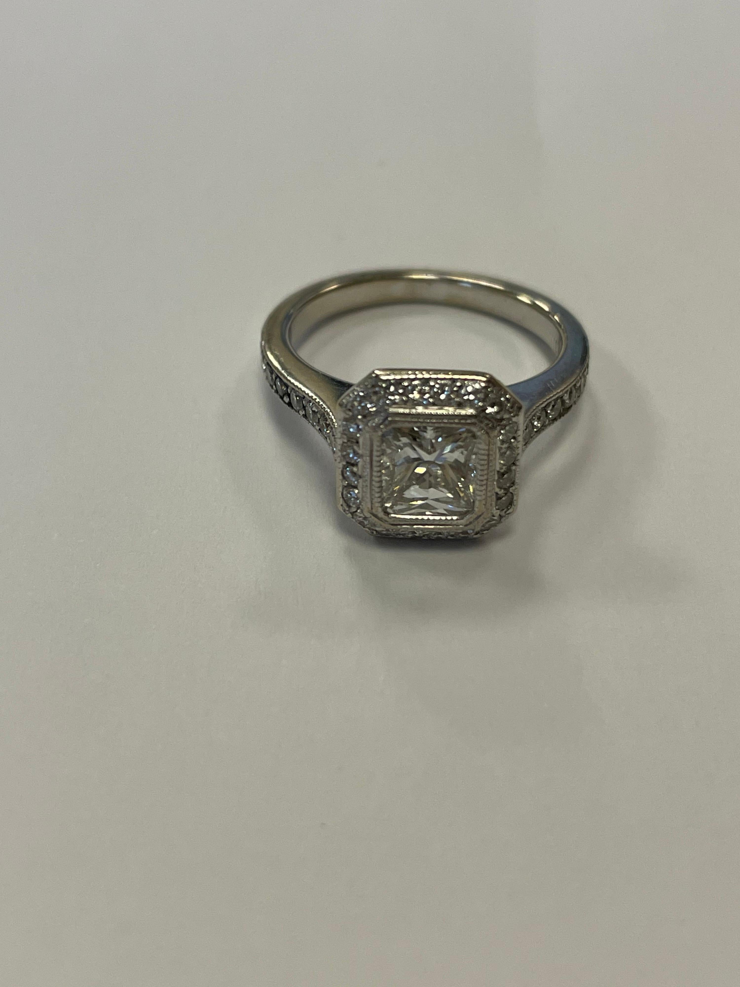 GIA certified Radiant cut diamond weighing .97cts, H color, SI1 clarity set in 18K white gold halo mounting with 40 full cut round diamonds weighing .46cts.
Finger size 6, may be sized
Last retail $8250