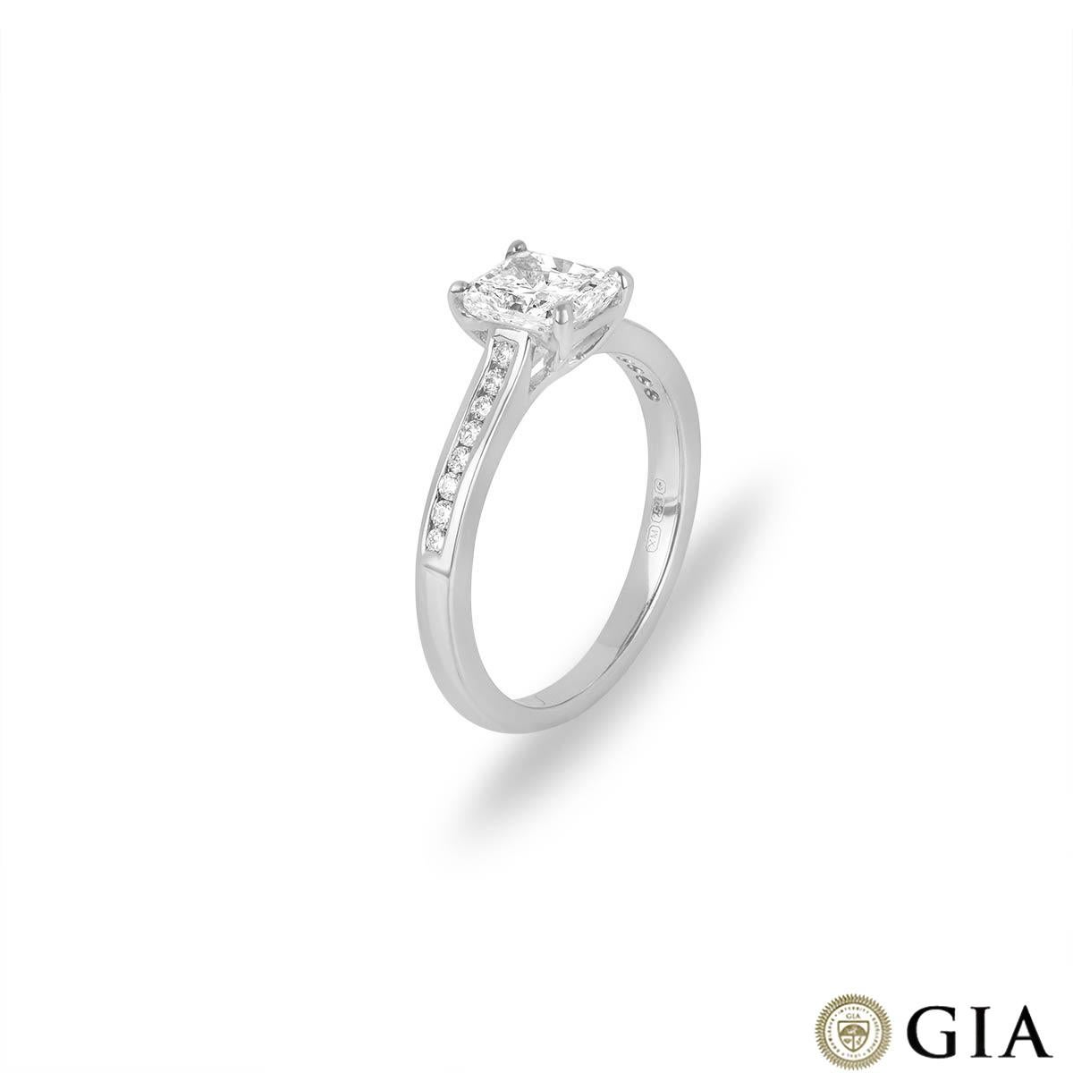 A radiant cut diamond ring set in 18k white gold. The radiant cut diamond weighs 1.01ct, the diamond is H colour and SI1 clarity. The centre stone is set within four claws and has diamond set shoulders.  The 16 round brilliant cut diamond side