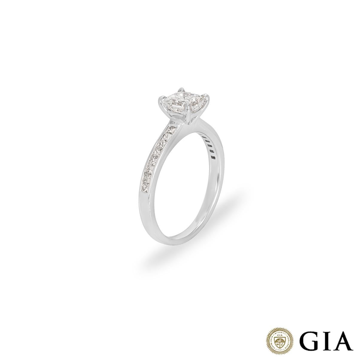 A radiant cut diamond ring set in 18k white gold. The radiant cut diamond weighs 1.01ct, the diamond is D colour and VVS2 clarity. The centre stone is set within four claws and has diamond set shoulders. The 16 princess cut side stones are well