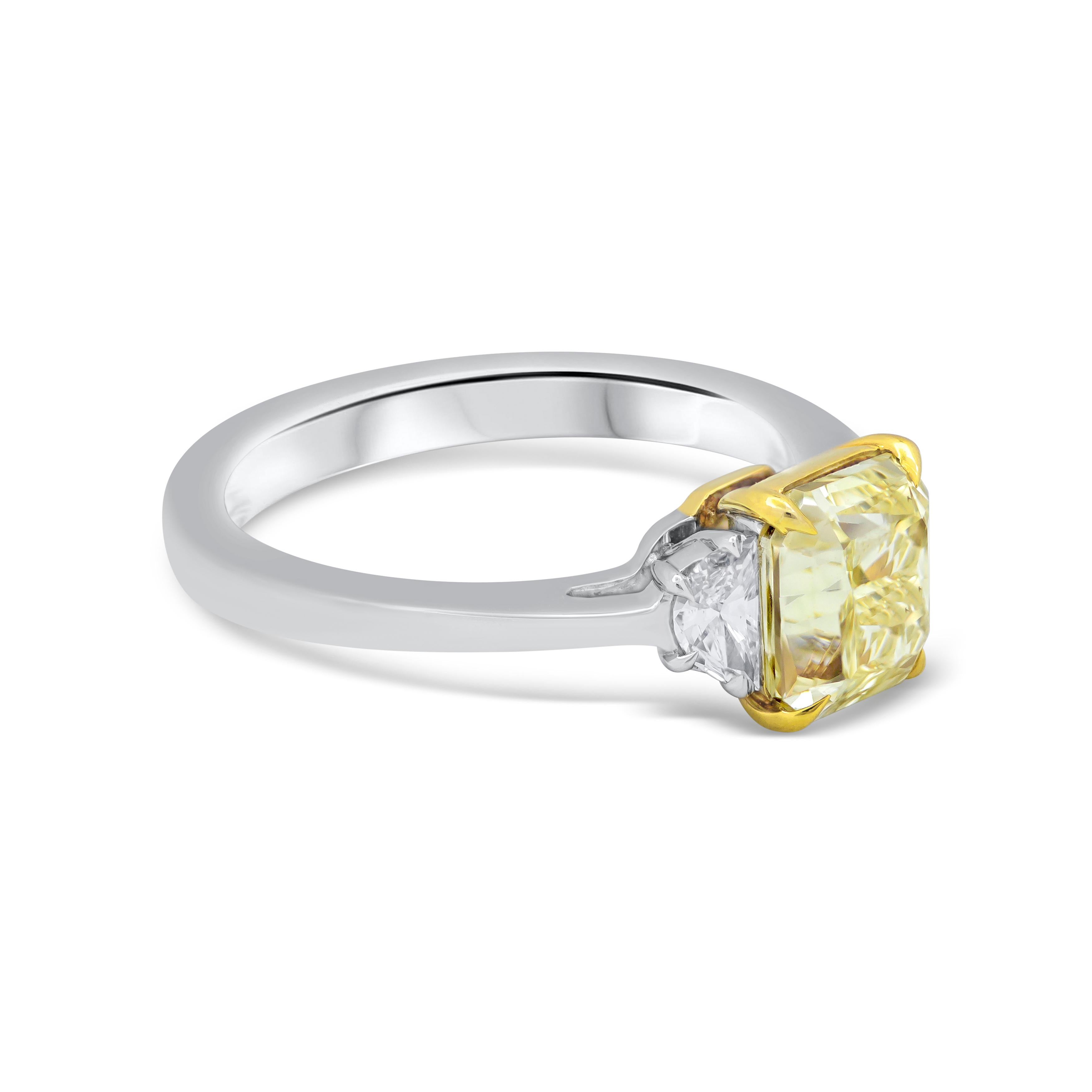 A simple and chic engagement ring features a 2.02 carats radiant cut diamond that GIA certified as Fancy Yellow color, VS2 in clarity, set in a 18k yellow gold four prong basket setting. Elegantly flanked by gorgeous half-moon diamonds in a platinum