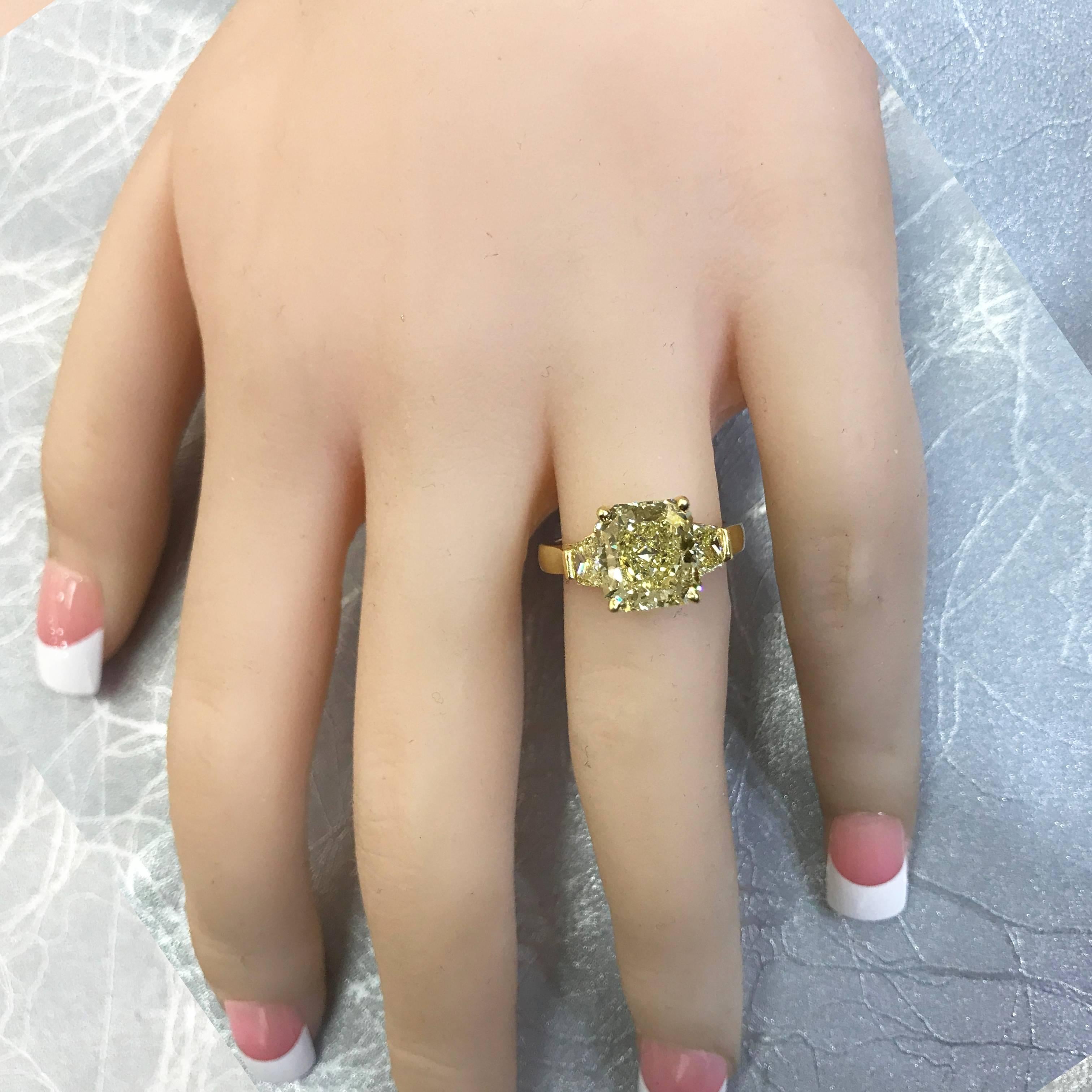 Make that proposal extra special with this exceptional yellow diamond engagement ring. Handcrafted in 18k yellow gold, this engagement ring features a 3.10 carat radiant cut diamond that GIA certified as Fancy Yellow color, VS1 clarity. Flanking the