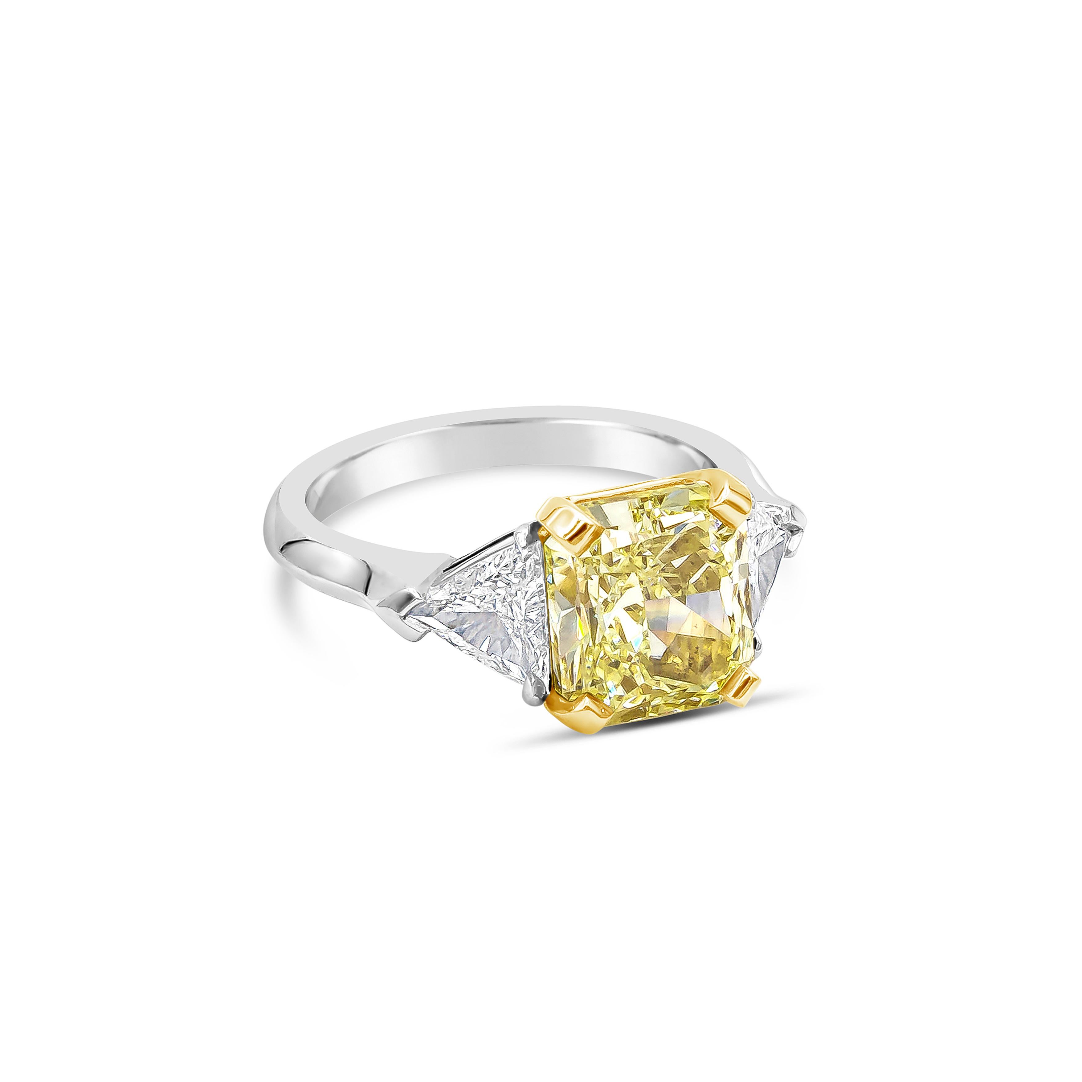Showcases a 4.06 carats radiant cut fancy yellow diamond that GIA certified as Fancy Yellow color, SI1 in clarity, accented by brilliant trillion cut diamonds on each side weighing 0.81 carats total. Set in an 18k yellow gold and platinum mounting.