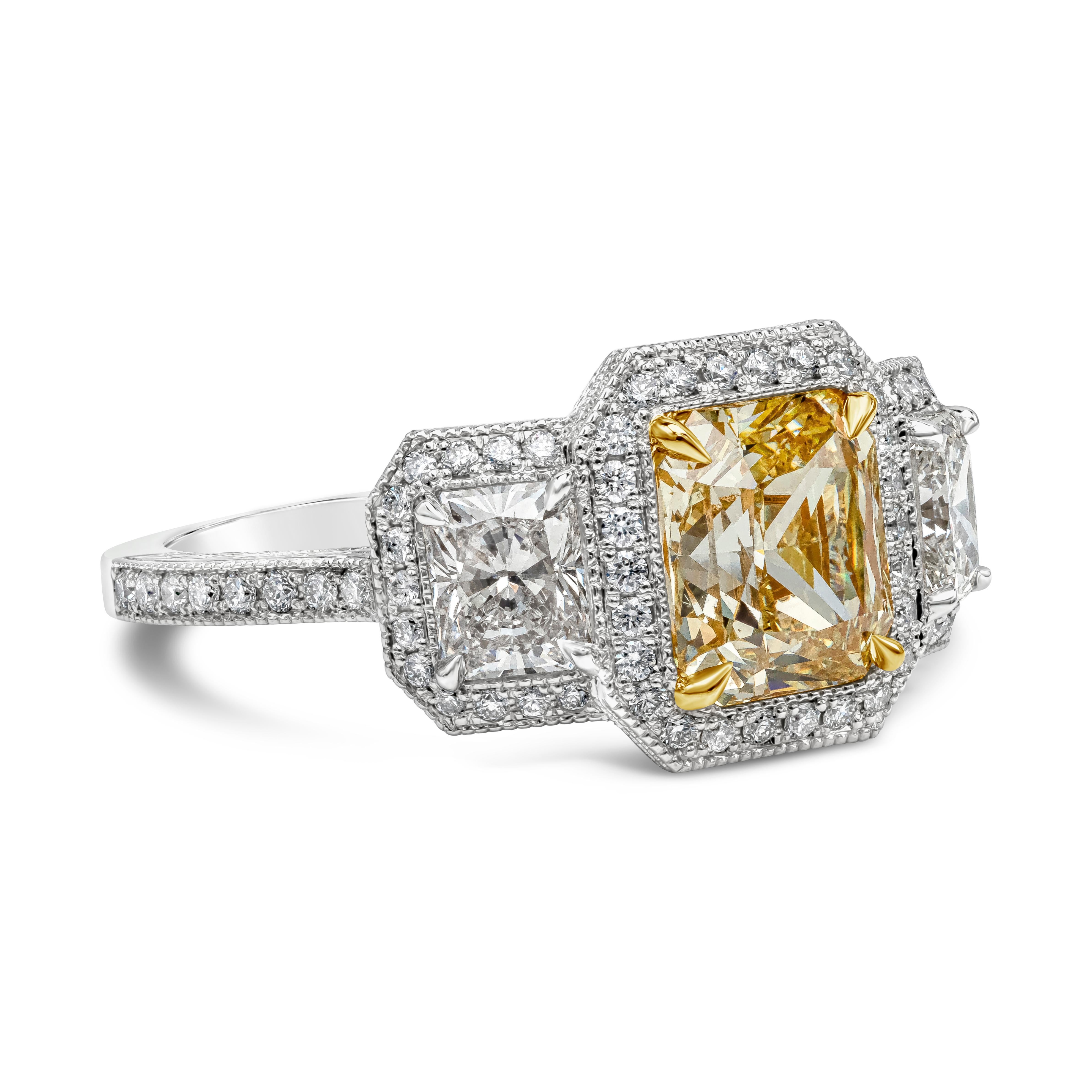 A unique handcrafted engagement ring showcasing a 1.96 carats radiant cut yellow diamond certified by GIA as Fancy Yellow color, SI1 in clarity, set in a four prong 18k yellow gold basket setting. Flanking the center diamond are two radiant cut