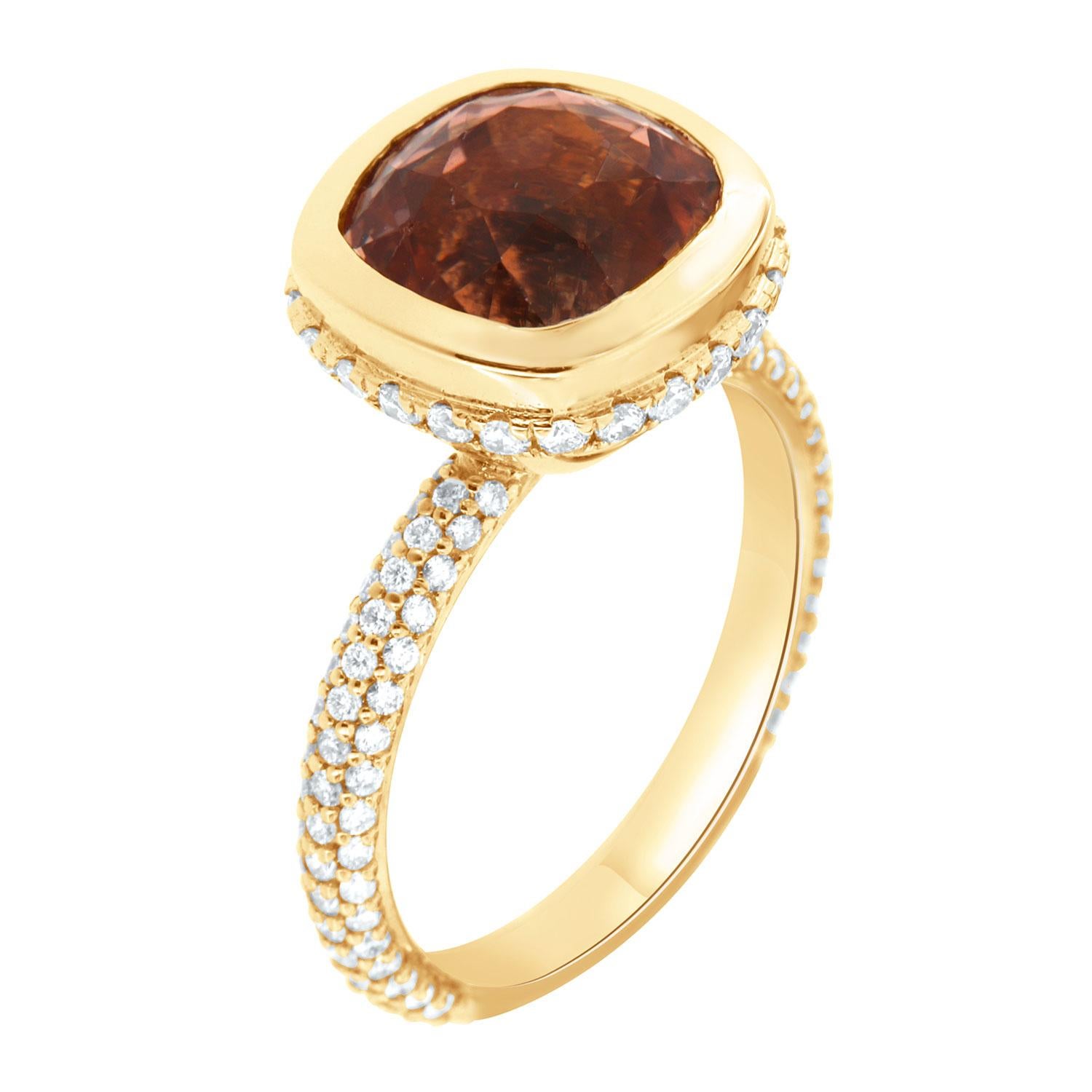 This 18k yellow gold ring features a GIA Certified rare 5.70-carat cushion shape Orange Tourmaline bezel set. Thirty (30) Brilliant round diamonds are micro-prong set in a hidden halo on the crown to create the sparkle look every woman is looking to