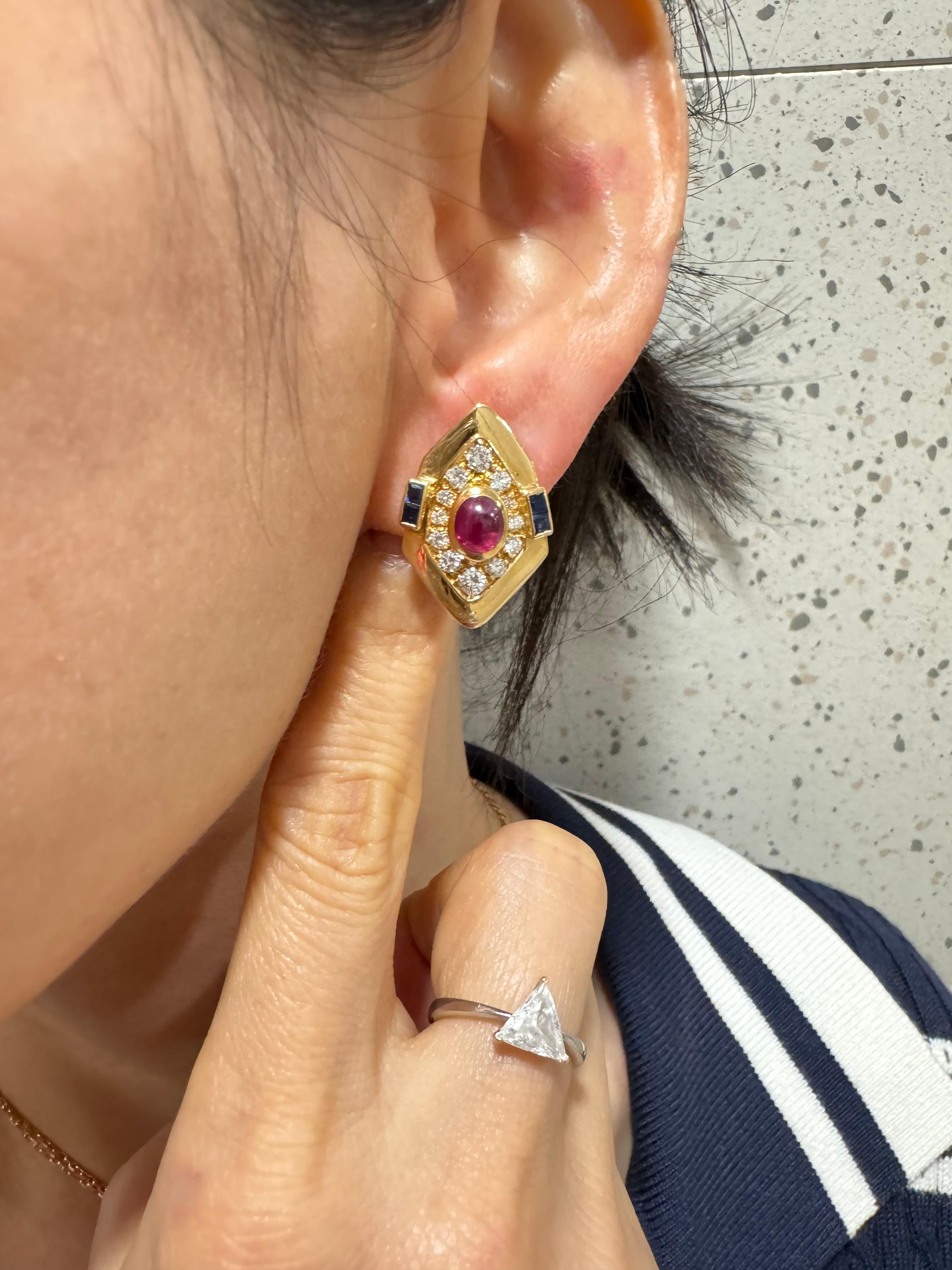 Please check out the HD video! These vintage earrings are very lively!  GIA certified pair of bright red Ruby, blue sapphire and diamond stud earrings. Set in 18k yellow gold, the center red rubies are about 1 cts each totaling 2cts. There are also