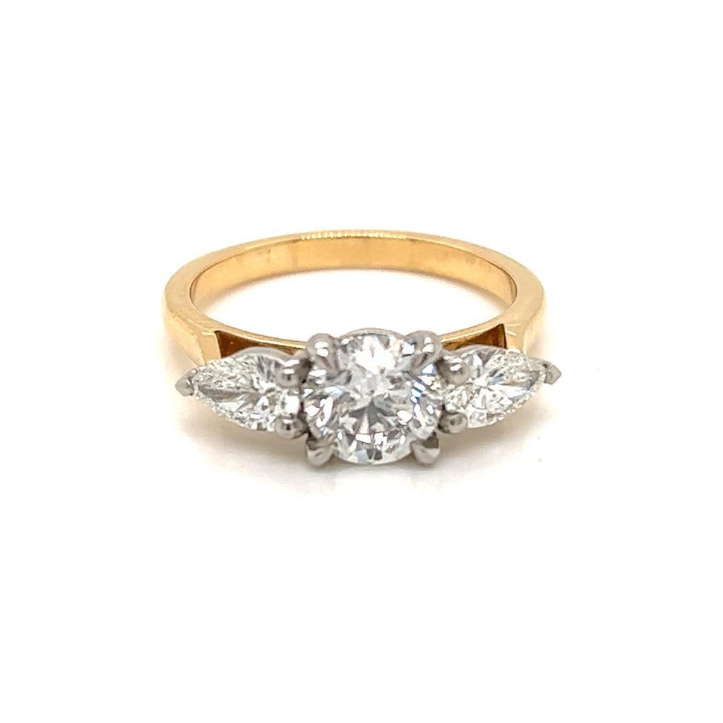 GIA Certified Round Brilliant and Pear Shape Diamond Ring in 18 Karat Yellow Gold and Platinum.

This gorgeous 18K Yellow Gold ring features a Round Brilliant Diamond with a Pear shape Diamond on either side of it held in a Platinum claw