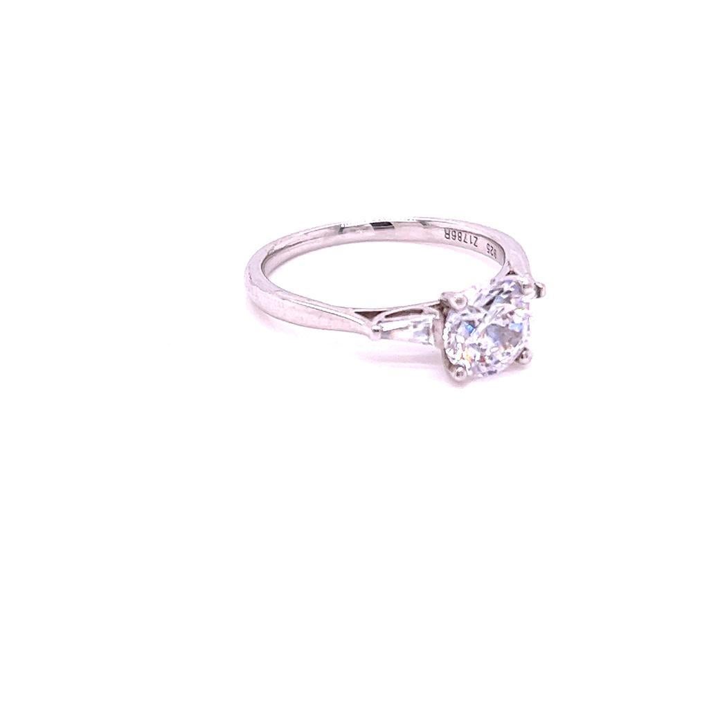 For Sale:  GIA Certified Round Brilliant and Baguette Diamond Three-Stone Ring in Platinum 3
