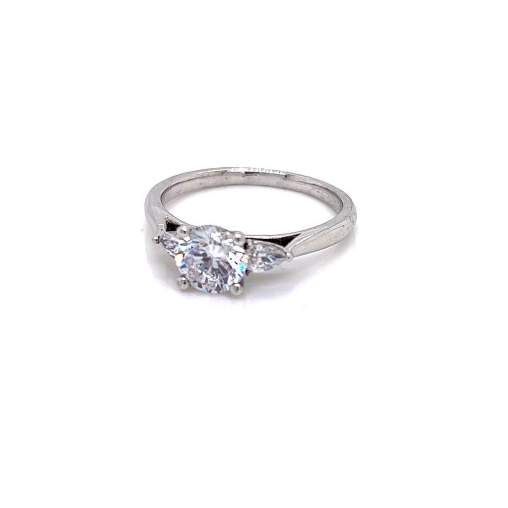 For Sale:  GIA Certified Round Brilliant and Pear Diamond Three-Stone Ring in Platinum 3