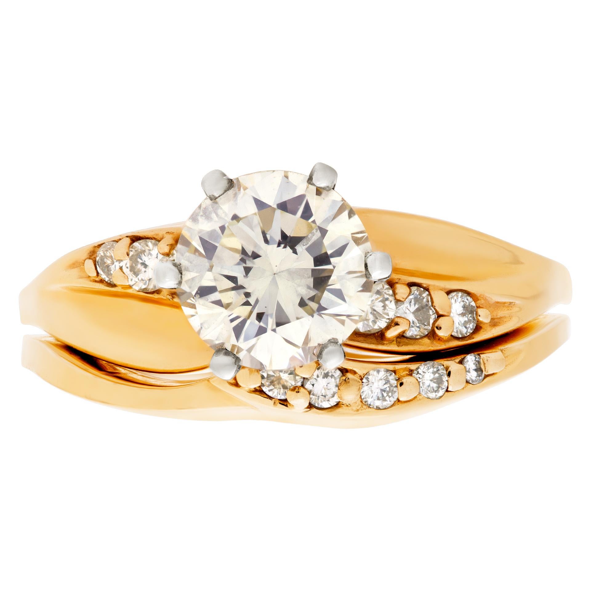 GIA certified round brilliant cut diamond 1.05 carat (W-X Color, VS-1 Clarity) ring set in a 14k yellow gold mounting with matching band with diamond accents. Size 6. This GIA certified ring is currently size 6 and some items can be sized up or