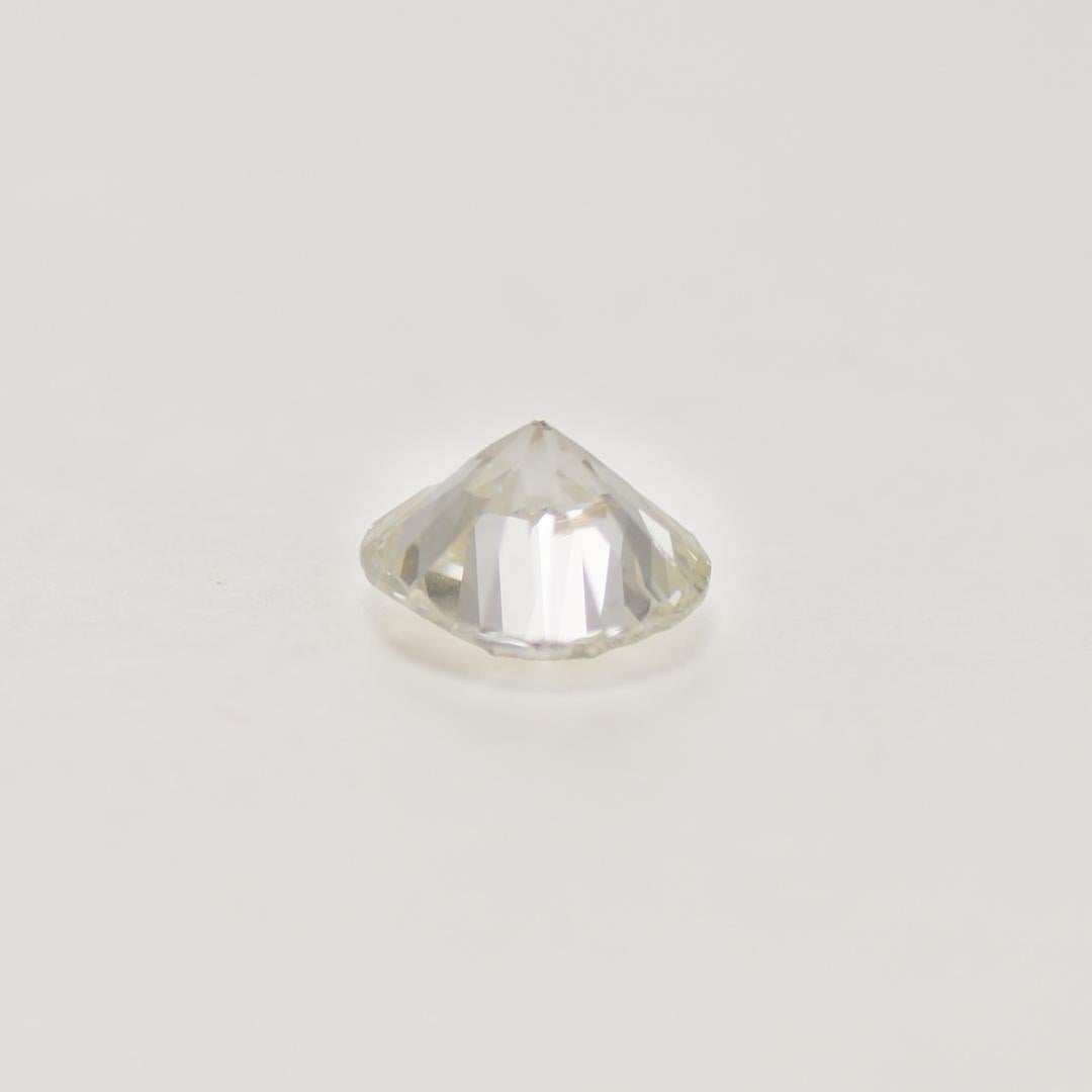 1.83-carat round brilliant cut diamond.
GIA grade J color, i1 clarity.
The two inclusions are located toward the edge and are hard to see without 10-power magnification.
Measures 7.73 - 7.90mm x 4.86mm.
The diamond faces up very brilliantly.
The GIA