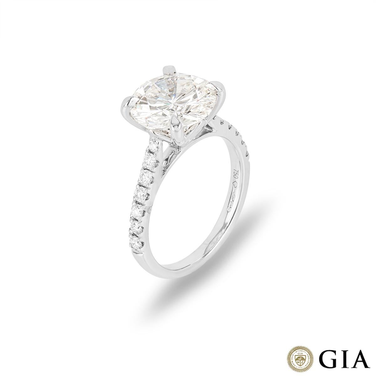 A spectacular 18k white gold diamond engagement ring. The engagement ring is set to the centre with a round brilliant cut diamond weighing 3.52ct, K colour and SI1 clarity. Complementing the impressive centre diamond are 14 round brilliant cut