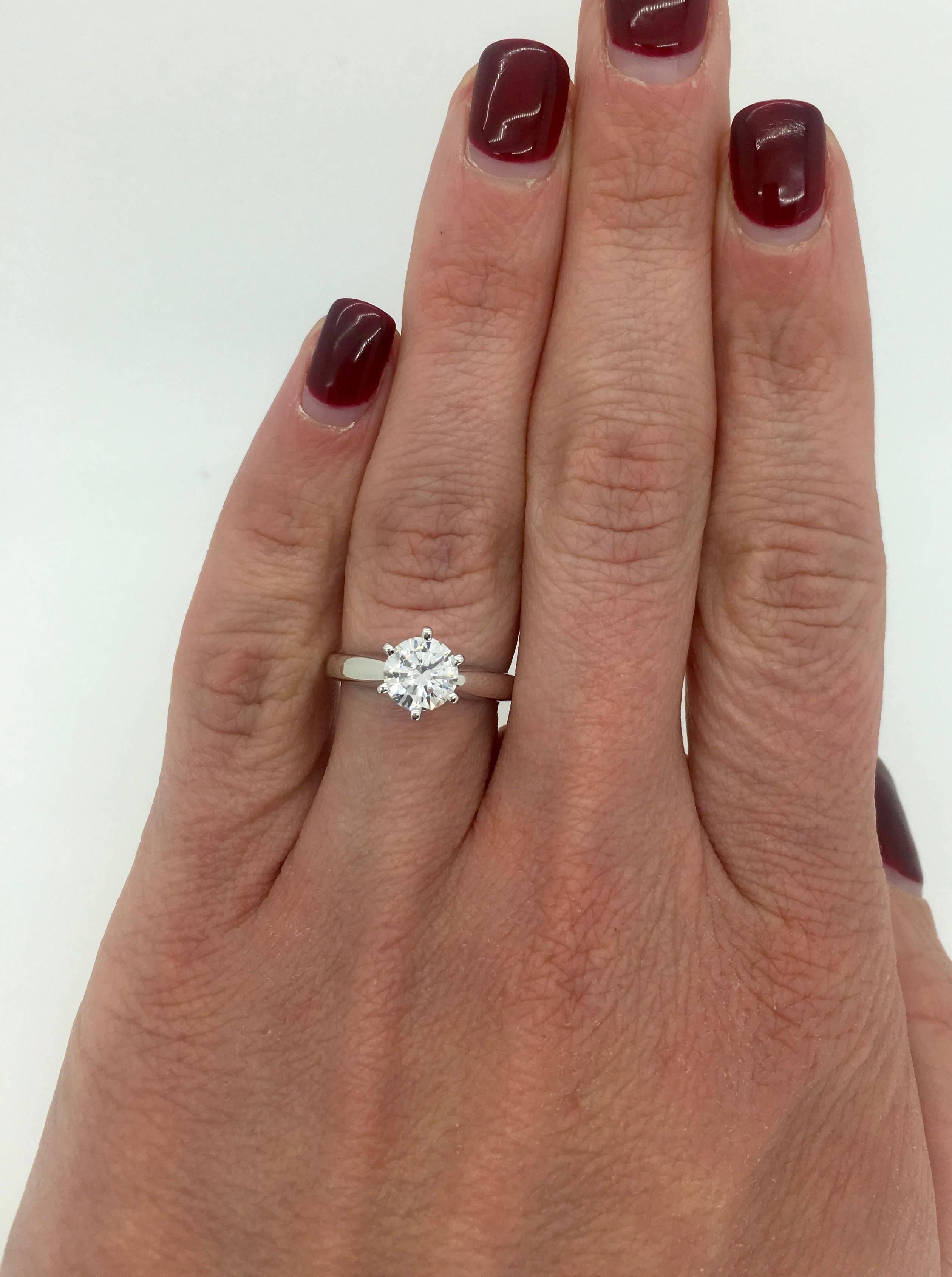 This classic 6 prong solitaire features a GIA Certified .90CT Round Brilliant Cut Diamond with I color and SI2 clarity. The 14k white gold ring is currently a size 5.25 and weighs 3.4 grams. The GIA Certification # is 12957059. The ring is stamped