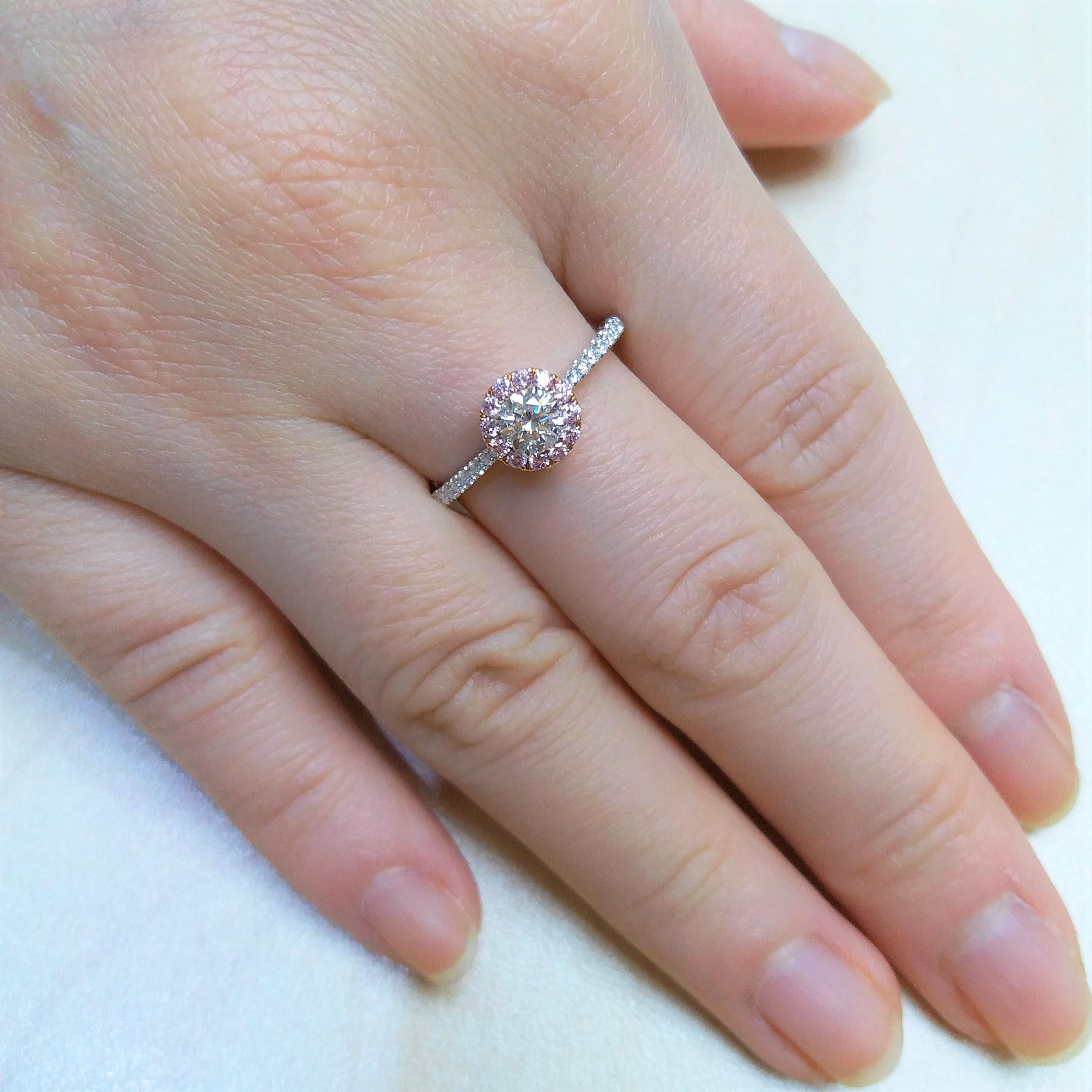 A stunning round White Diamond at the center, beautifully framed by a delicate halo of rare pink diamonds, exuding elegance and luxury.

Round shape White diamond (GIA certified)- 0.30 cts
Round Brilliant Cut Natural Pink Diamonds - 0.13 cts
Round