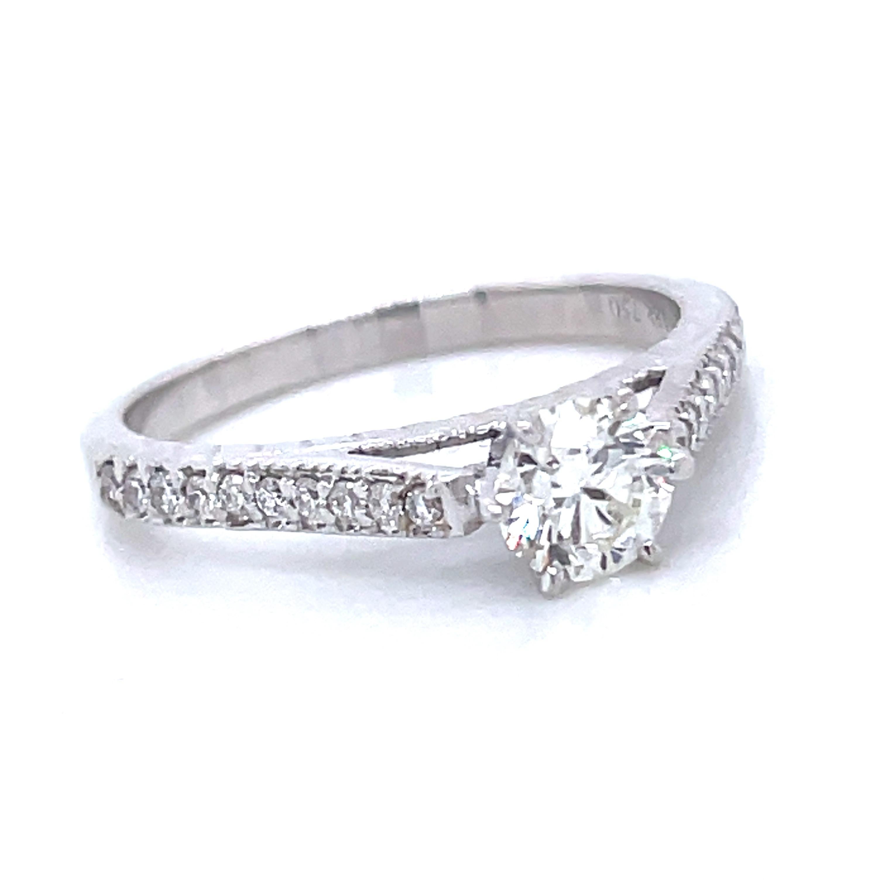 Deep breaths, because this ring is a showstopper! 

It’s an exquisite ring boasts an 18k white gold band weighing 3.18 grams, setting the stage for a mesmerizing Round Brilliant Diamond certified by GIA. 

With a weight of 0.51 carats and a color