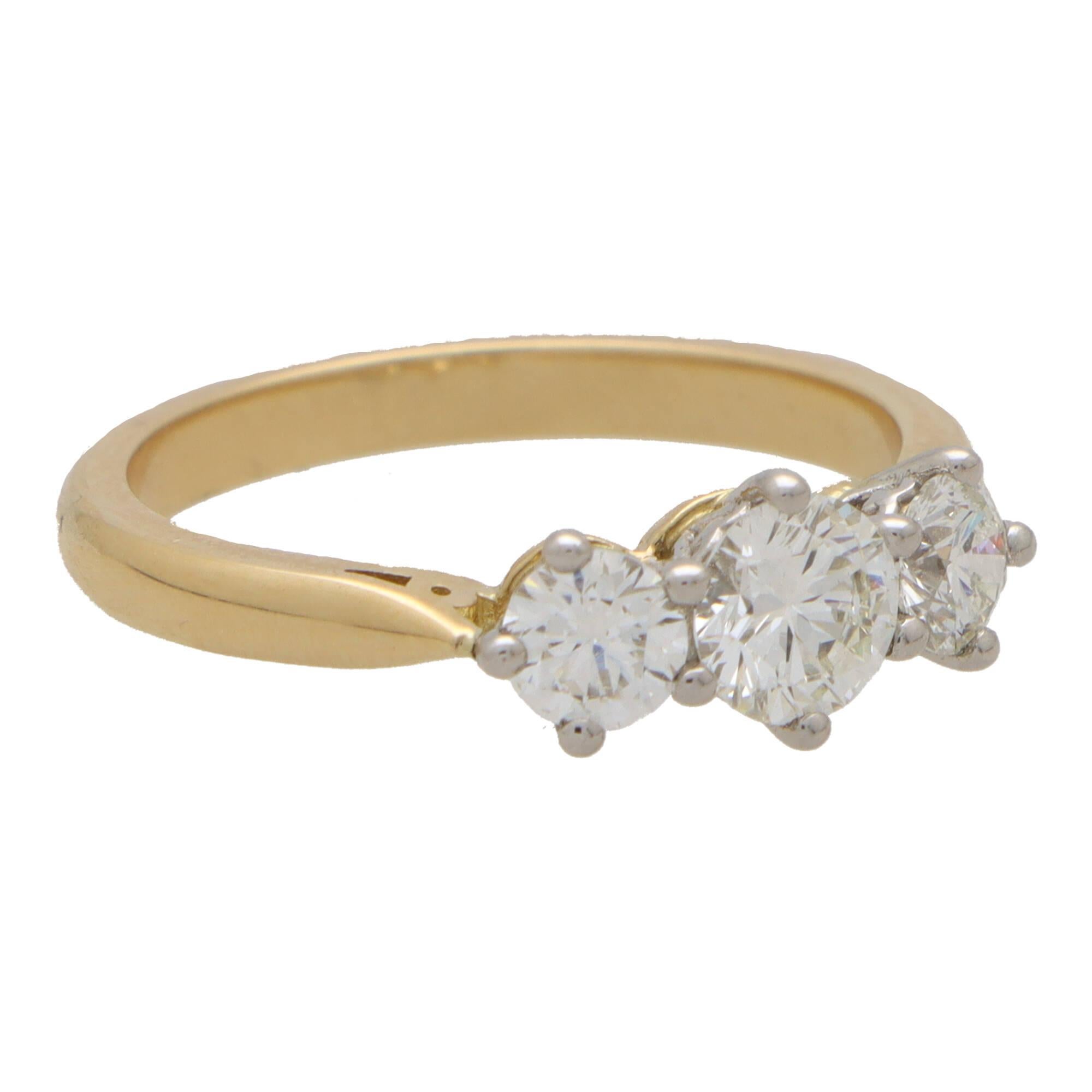  A beautiful certified diamond three stone engagement ring set in 18k yellow gold.

The ring is centrally set with a sparkly certified 0.50 carat round brilliant cut diamond. This is then sided by two perfectly matched 0.52 carat round brilliant cut