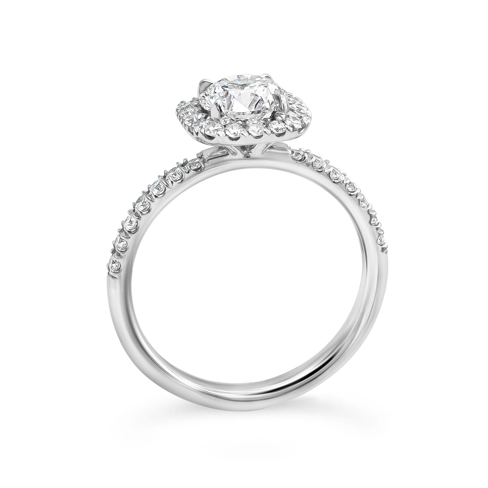A well-crafted engagement ring style showcasing a 1.01 carats round brilliant diamond certified by GIA as F color, SI2 in clarity. Surrounded by round brilliant diamonds in a halo setting. Shank made in platinum is encrusted with diamonds set in a