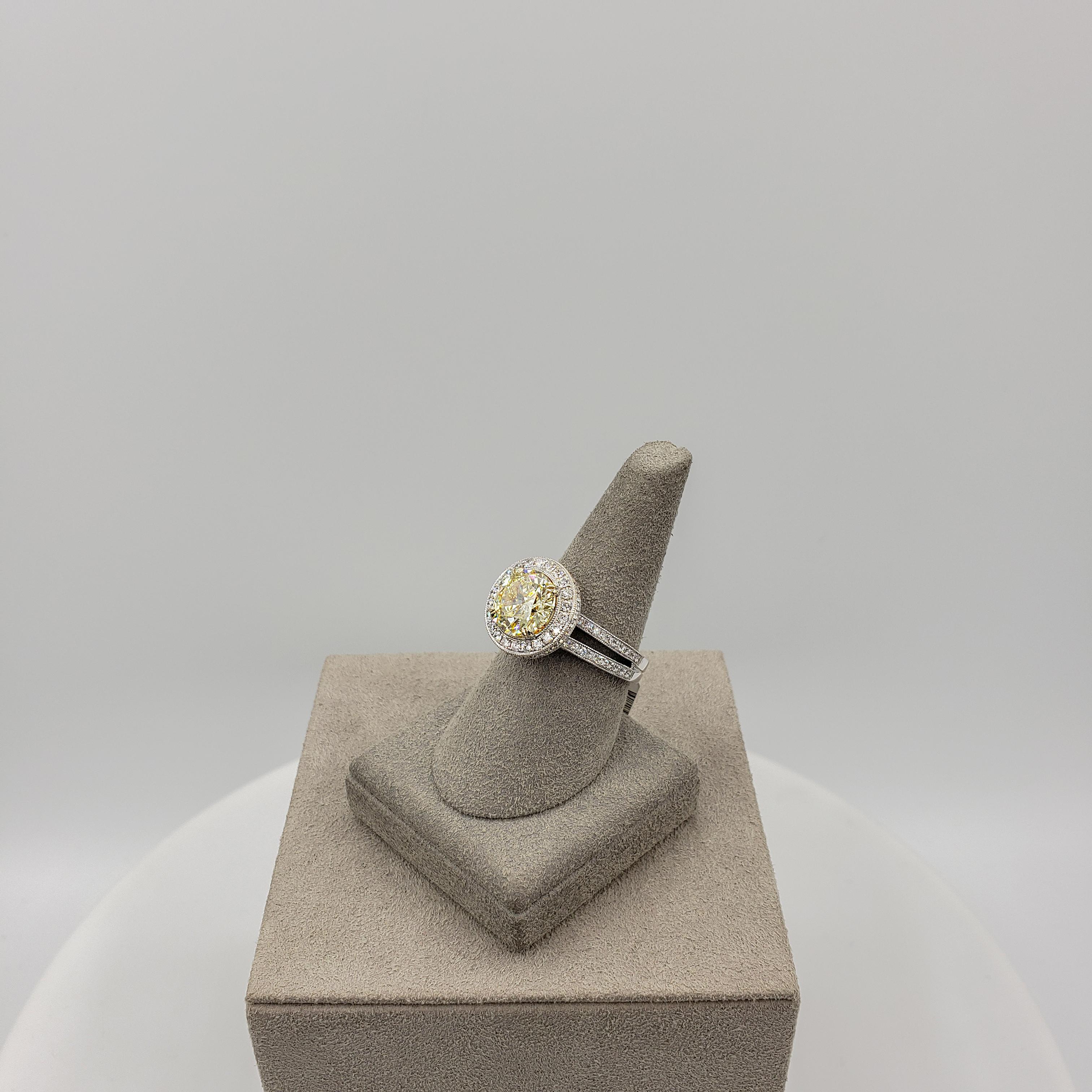 Contemporary GIA Certified 3.08 Carat Round Yellow Diamond Halo Engagement Ring in White Gold For Sale
