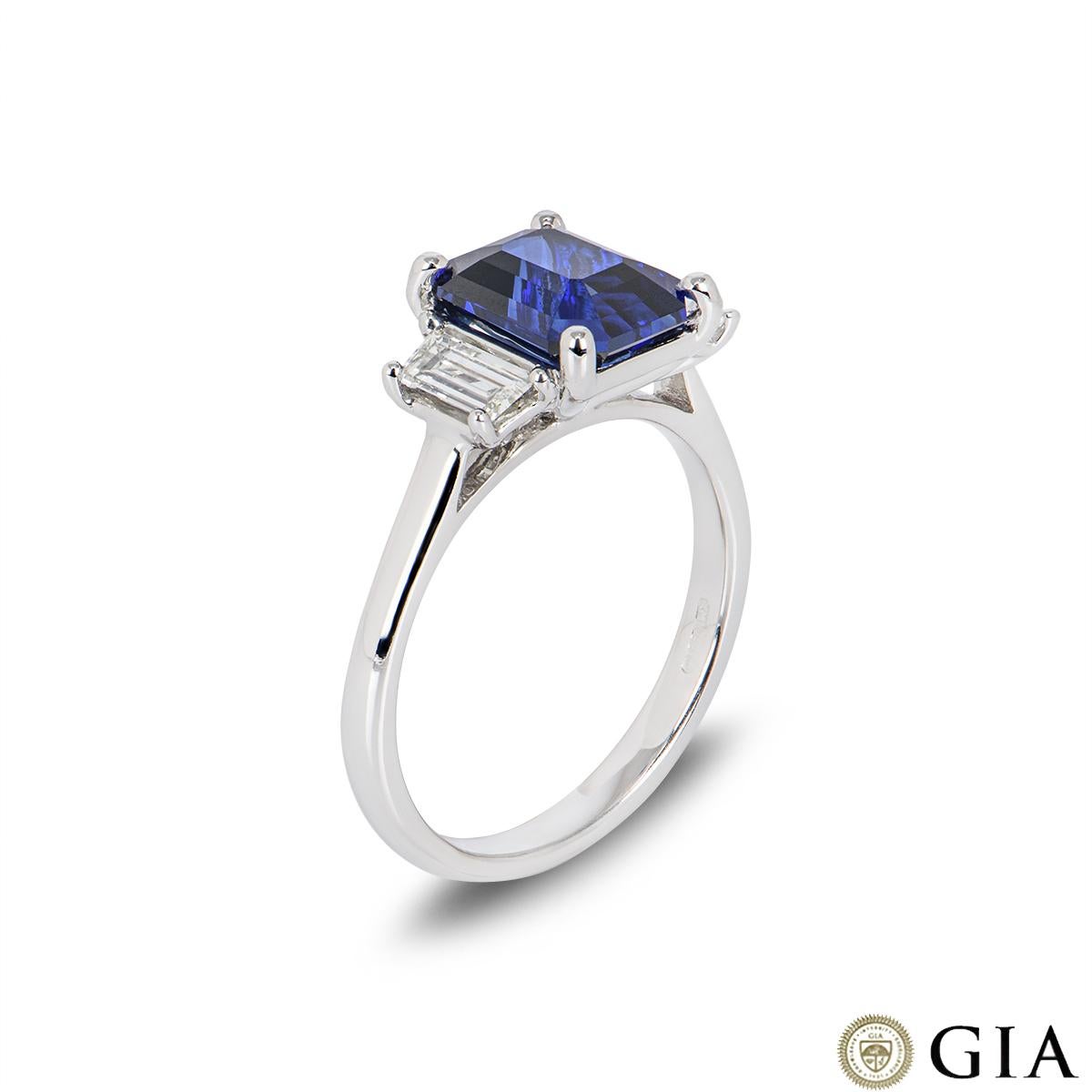 A beautiful 18k white gold royal blue sapphire and diamond ring. The royal blue octagonal step-cut sapphire weighs 3.04ct and displays signs of heat treatment. Set to either side of the sapphire are 2 tapered baguette cut diamonds with a total