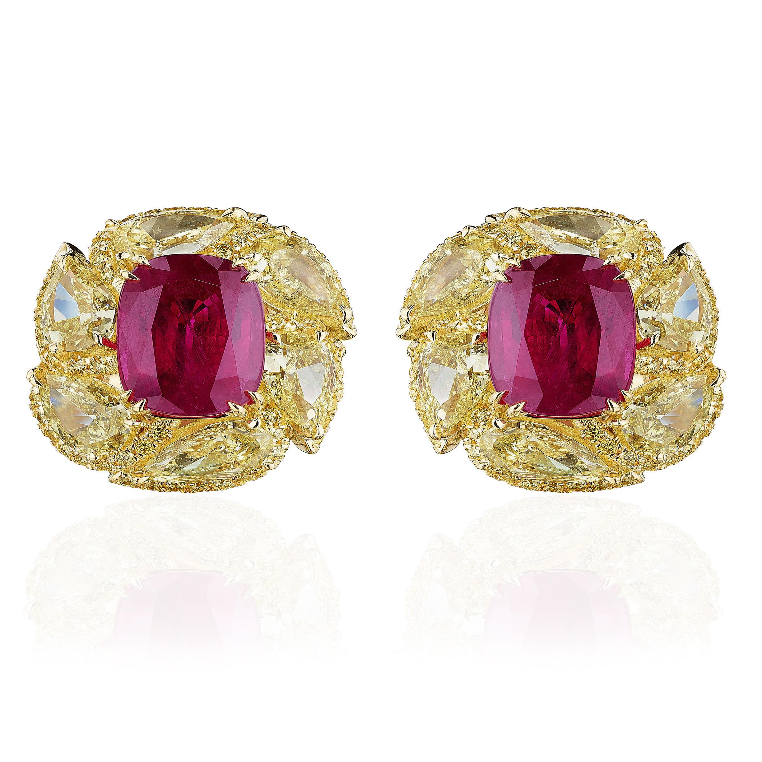 Centered upon 2 elongated Rubies weighing a total of 7.63 Carats.
Certified by GIA as Heated.

Surrounded by Pear shaped Yellow Diamonds and Round Yellow Diamonds weighing 5.20 Carats.

Set in 18 Karat Yellow Gold