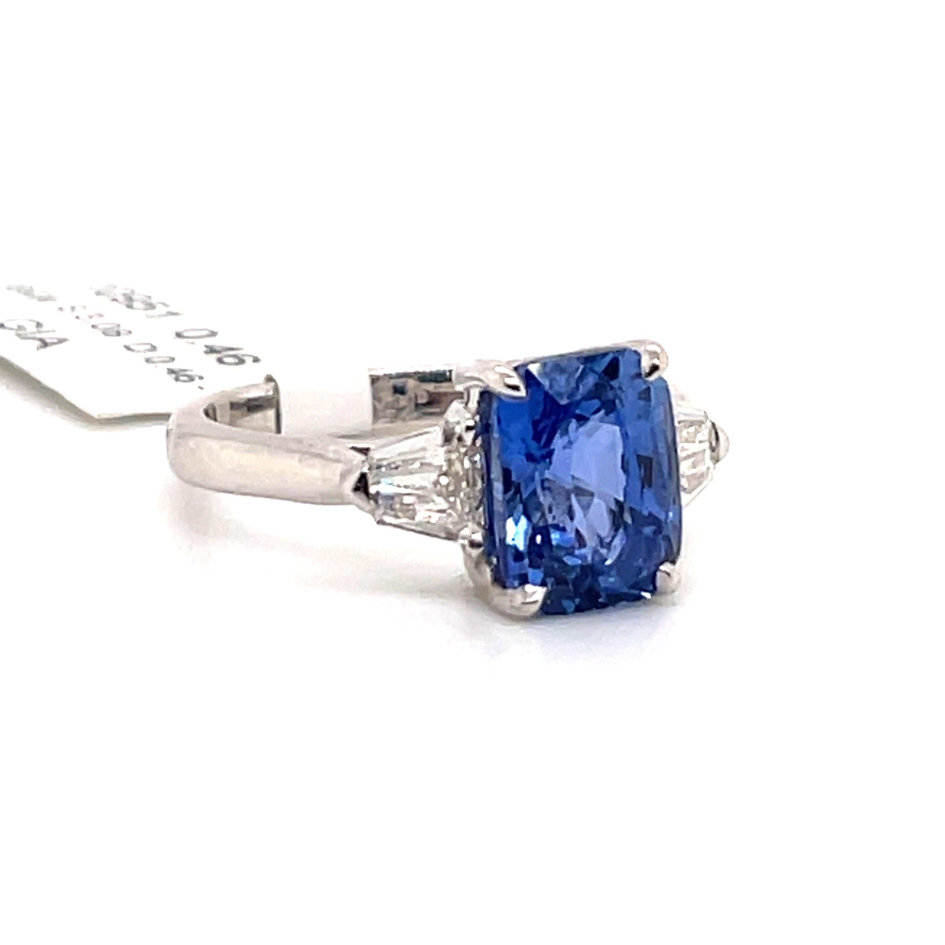 GIA Certified no heat blue Sapphire weighing 3.08 carats flanked with bullet diamonds weighing 0.46 carats, in 18k white gold.
