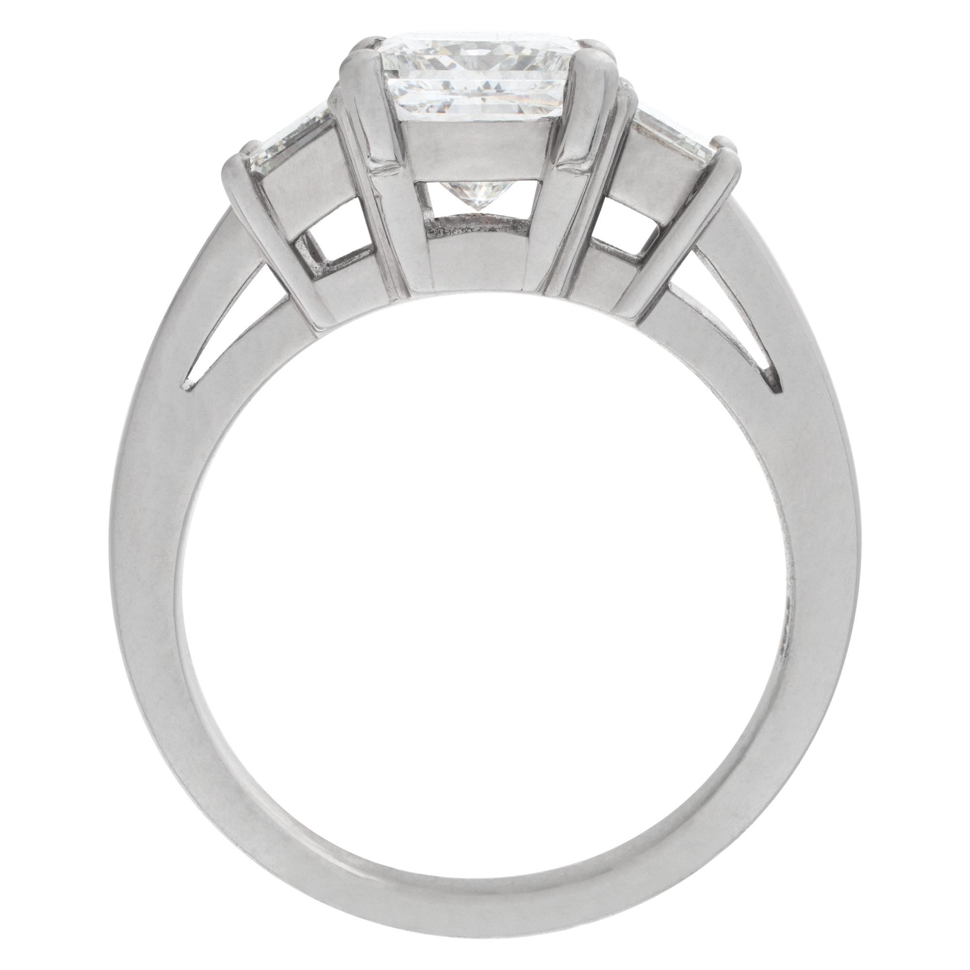ESTIMATED RETAIL: $45,750.00
G&S PRICE: $34,160.00

GIA certified square modified brilliant cut diamond 2.03 carat (G color, VS1 clarity) ring set in platinum mounting. Mounting has 2 emerald cut side diamond, approximately 0.70 carats total weight-