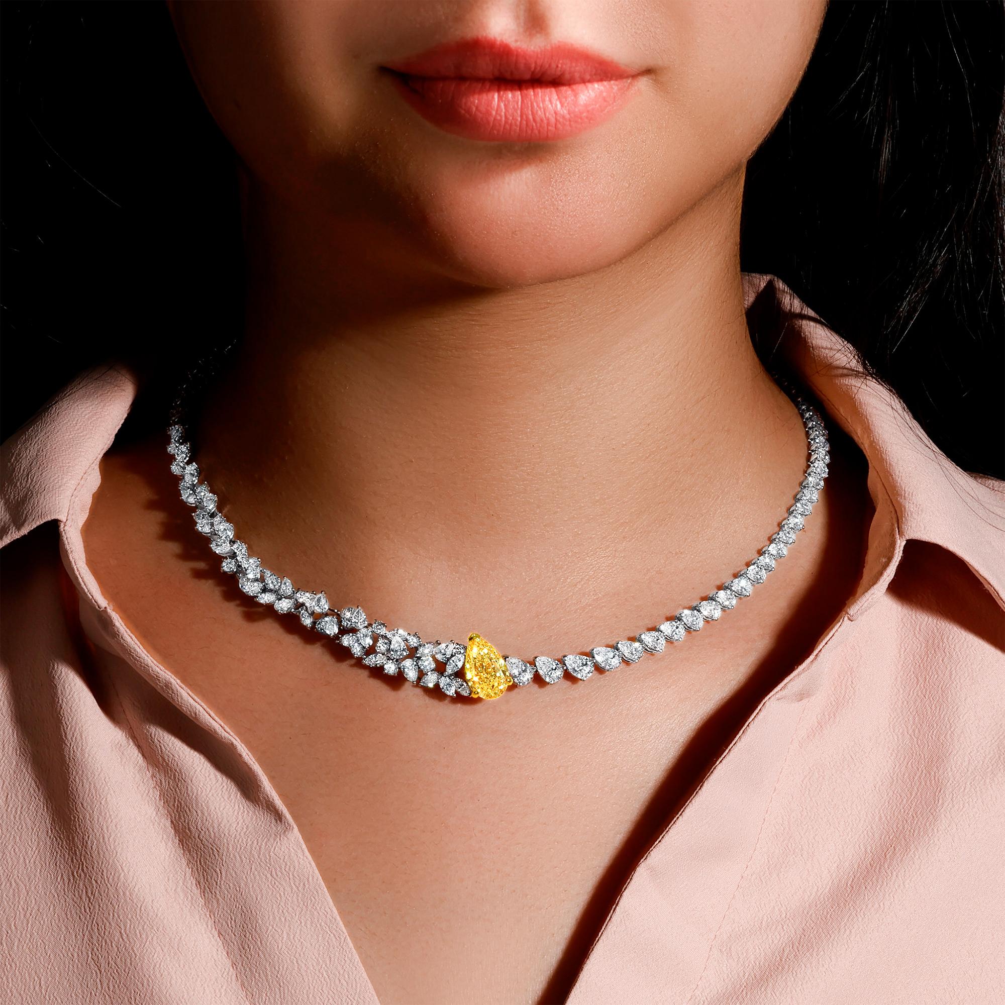 It comes with the GIA Certificate
All Gemstones are Natural
GIA Certified Yellow Diamond = 4.72 Carat
Cut: Pear, Color: Y-Z, Clarity: VS2
110 White Diamonds = 13.91 Carats
Cut: Pear, Marquise, Round
Metal: 18K White Gold
Necklace Length: 16