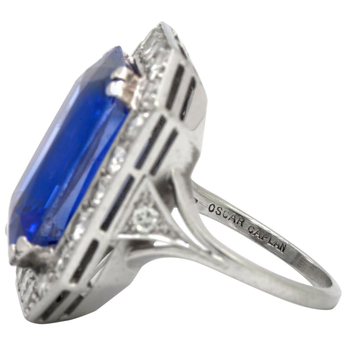 A Synthetic Sapphire classic octagonal cocktail ring with a rich blue Synthetic Sapphire which weighs approximately 12.50 cts, surrounded by 22 round brilliant cut diamonds that have an approximate total weight of 1.50 cts, that have been set in 18k