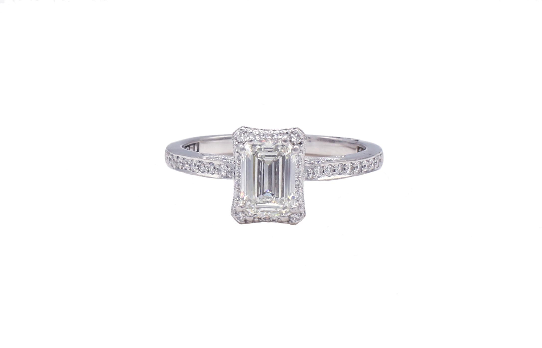 GIA Certified Tacori Emerald Cut 1.18 Carat I SI1 Diamond 18 Karat White Gold Halo Engagement Ring

GIA report number: 2161414052
Diamond: 1.18 carat emerald cut I SI1
Accent diamonds: Approx. .33 CTW G VS round diamonds
Size: 8 (US)
Top: 9 x