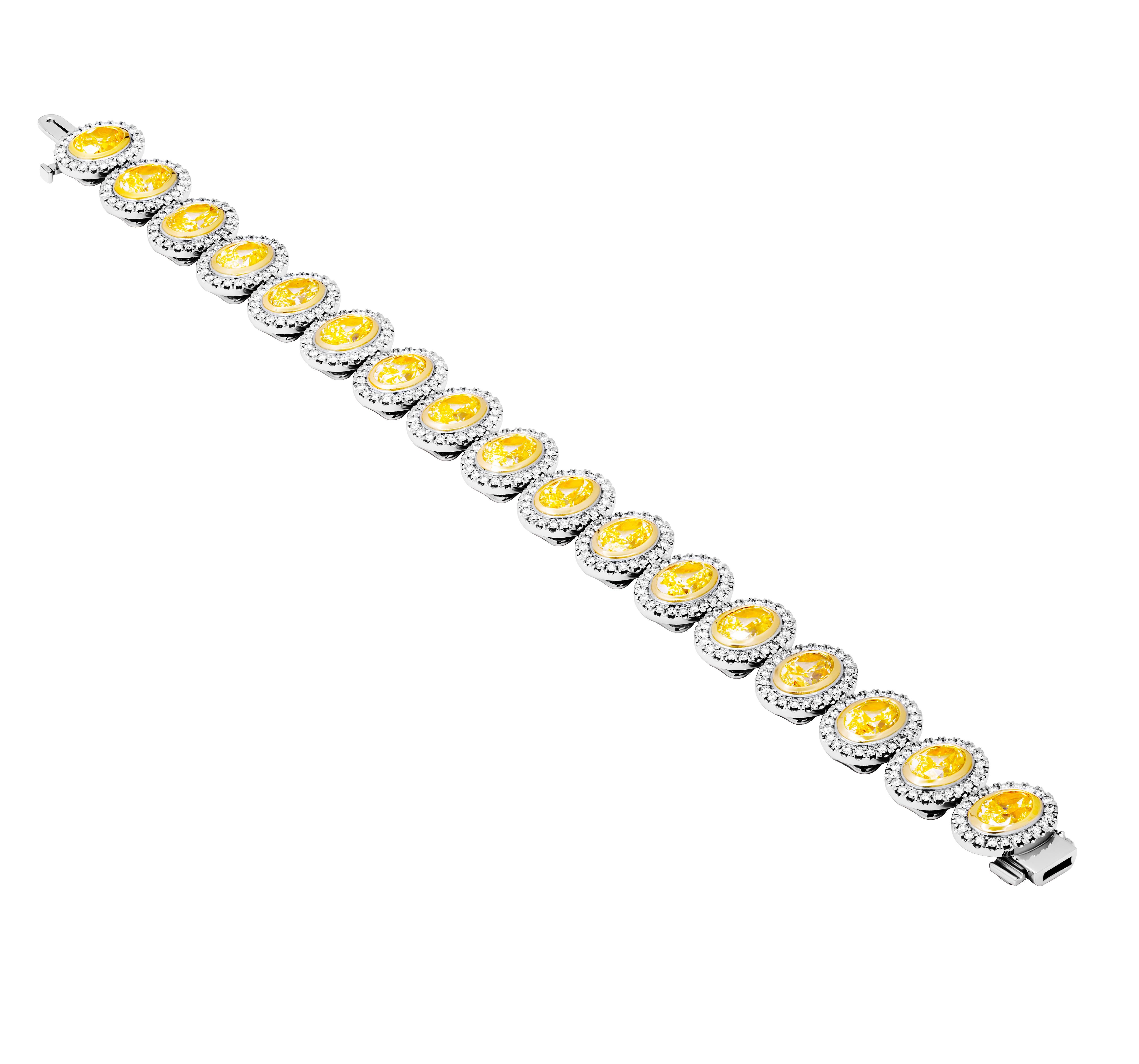 GIA Certified Tennis Bracelet with Oval Yellow Diamonds in 18k Yellow Gold &Platinum
With pave halo around each stone
 Total Carat Weight of small white diamonds: 2.70ct 17 stones Q-R/W-X/Y-Z/S-T/U-V Natural Yellow oval diamonds
1.00 VS1