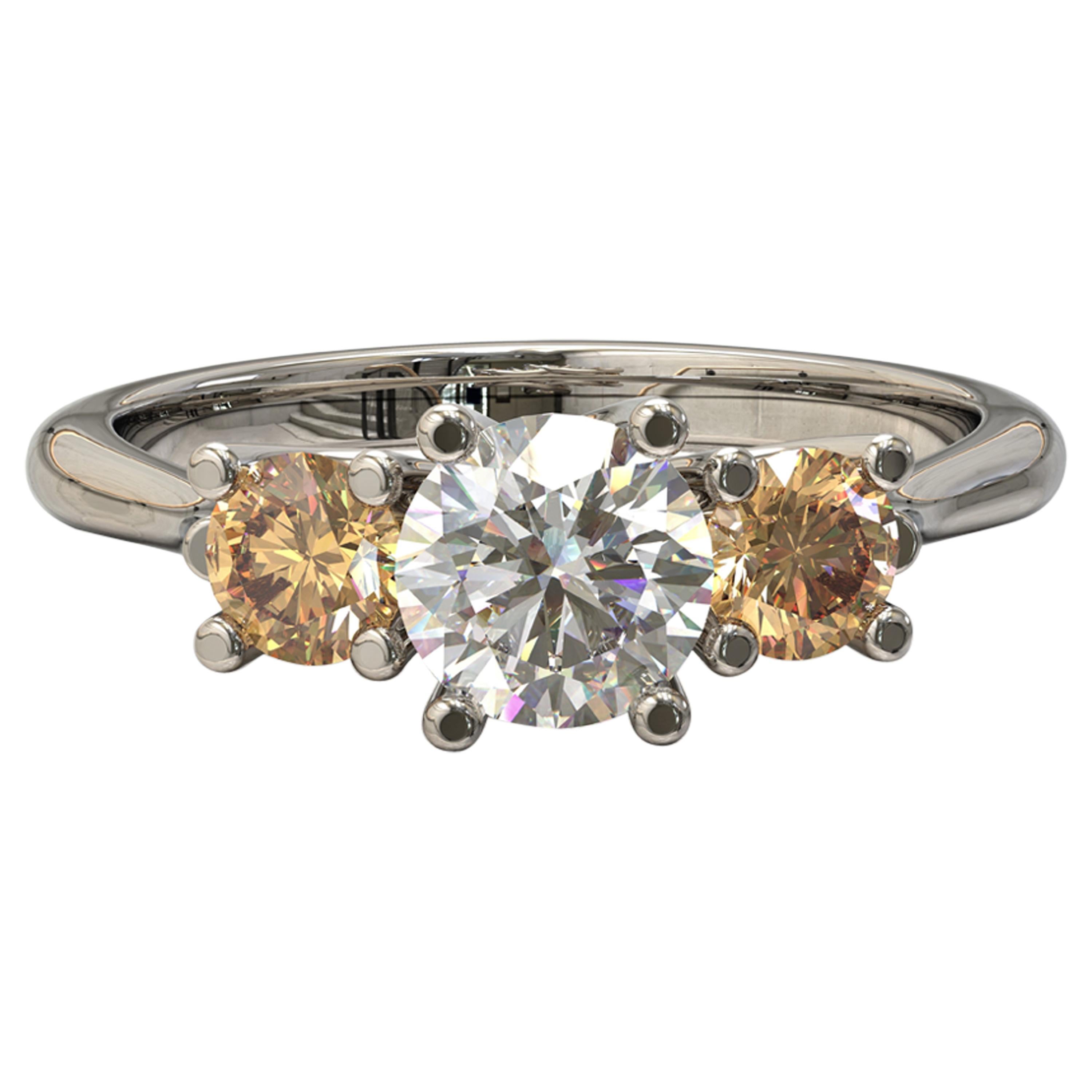Ring with a trio of gemstones

Centrally set within a round brilliant cut  diamond displays a beautiful vitreous lustre. Two round golden champagne diamonds are similarly set on either side. Simply gorgeous.
Round brilliant cut diamond: 
1= 0.5