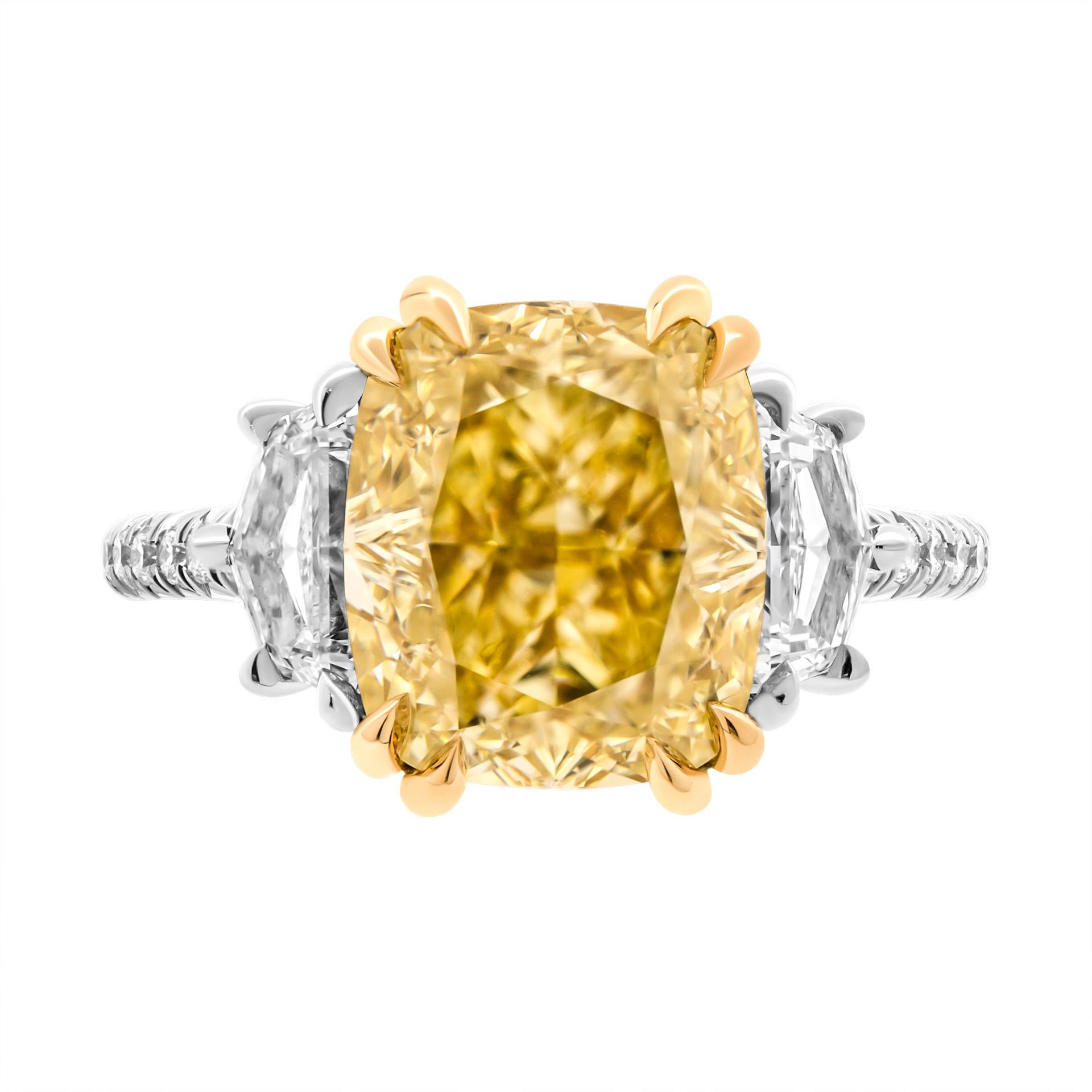 GIA Certified Three stone ring in 18K Yellow Gold & Platinum 
Center stone: 5.18ct Natural Fancy Yellow Even VS1 Cushion Shape Diamond GIA#5221603614 
Two side stones: 0.50ct D IF GIA#2404971434 Cadillac shape diamond
                            