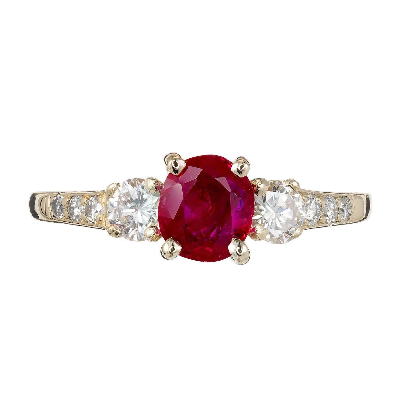 Tiffany & Co vintage 1960s GIA certified natural no heat 0.74ct Ruby and Diamond three-stone engagement ring. 18k yellow gold setting with accent diamonds. 

18k yellow gold
1 oval purplish reed Ruby, approx. total weight .74cts, 5.64 x 5.0mm,