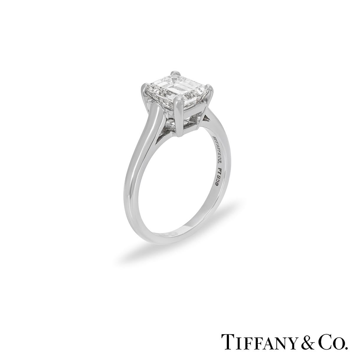 A stunning platinum diamond single stone ring by Tiffany & Co. The solitaire features an emerald cut diamond weighing 1.59ct, E colour and VS1 clarity set in a four prong mount. The 2mm ring has a gross weight of 4.9 grams and is currently a UK size
