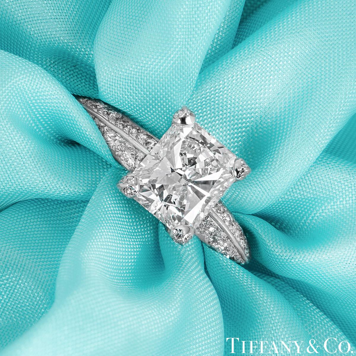 A stunning platinum diamond engagement ring by Tiffany & Co. The ring is set to the centre with a radiant cut diamond in an exquisite four claw mounting, weighing 2.01ct, G colour and IF (internally flawless) clarity. The knife edge engagement ring