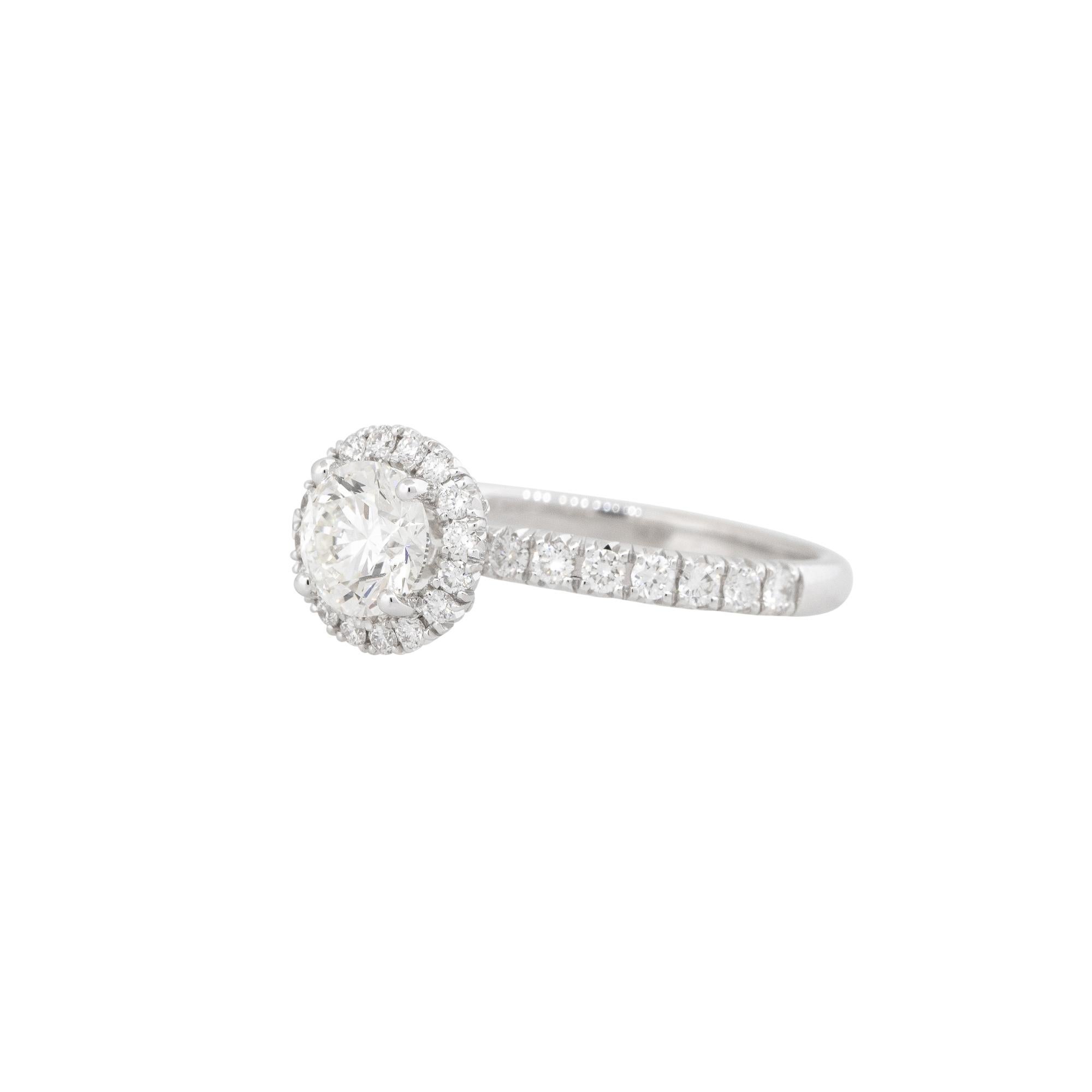This GIA certified 1.52 carat diamond halo engagement ring is a stunning example of timeless elegance and exceptional craftsmanship. The centerpiece of the ring is a brilliant round cut diamond, weighing in at 0.80 carats, that has been expertly