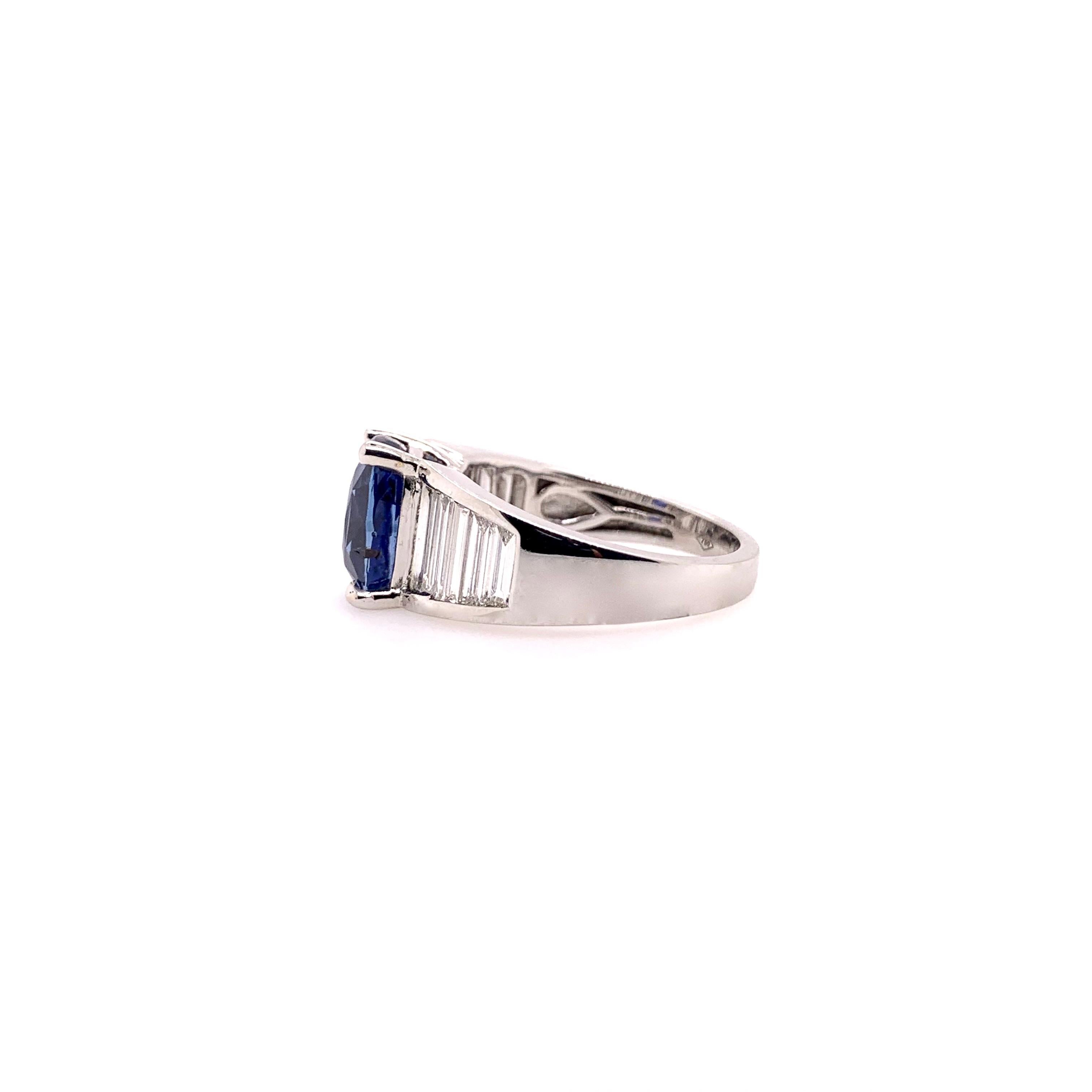 A rare unheated, GIA certified blue sapphire ring set in an 18k white gold, classic elongated baguette diamond setting.  The 4.06 ct. royal blue color sapphire commands the attention and is accentuated with the 0.99 cts. total weight diamond