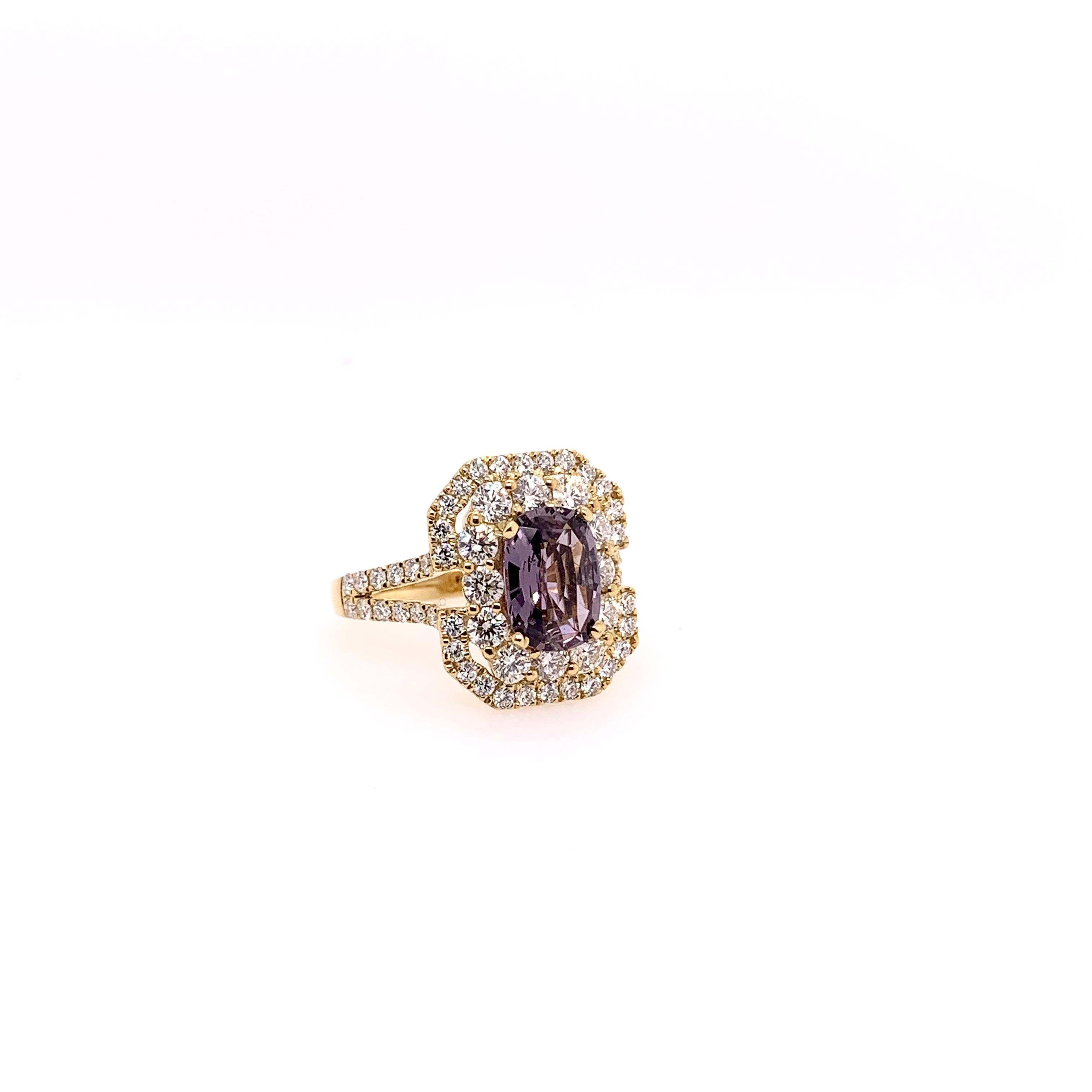 This unique ring has a very unusual center stone.  It is a GIA certified, unheated natural purple sapphire that weighs 2.06 carats.  The soft purple hue is complemented by the 1.58 carats of round brilliant diamonds and set in the 18k yellow gold. 