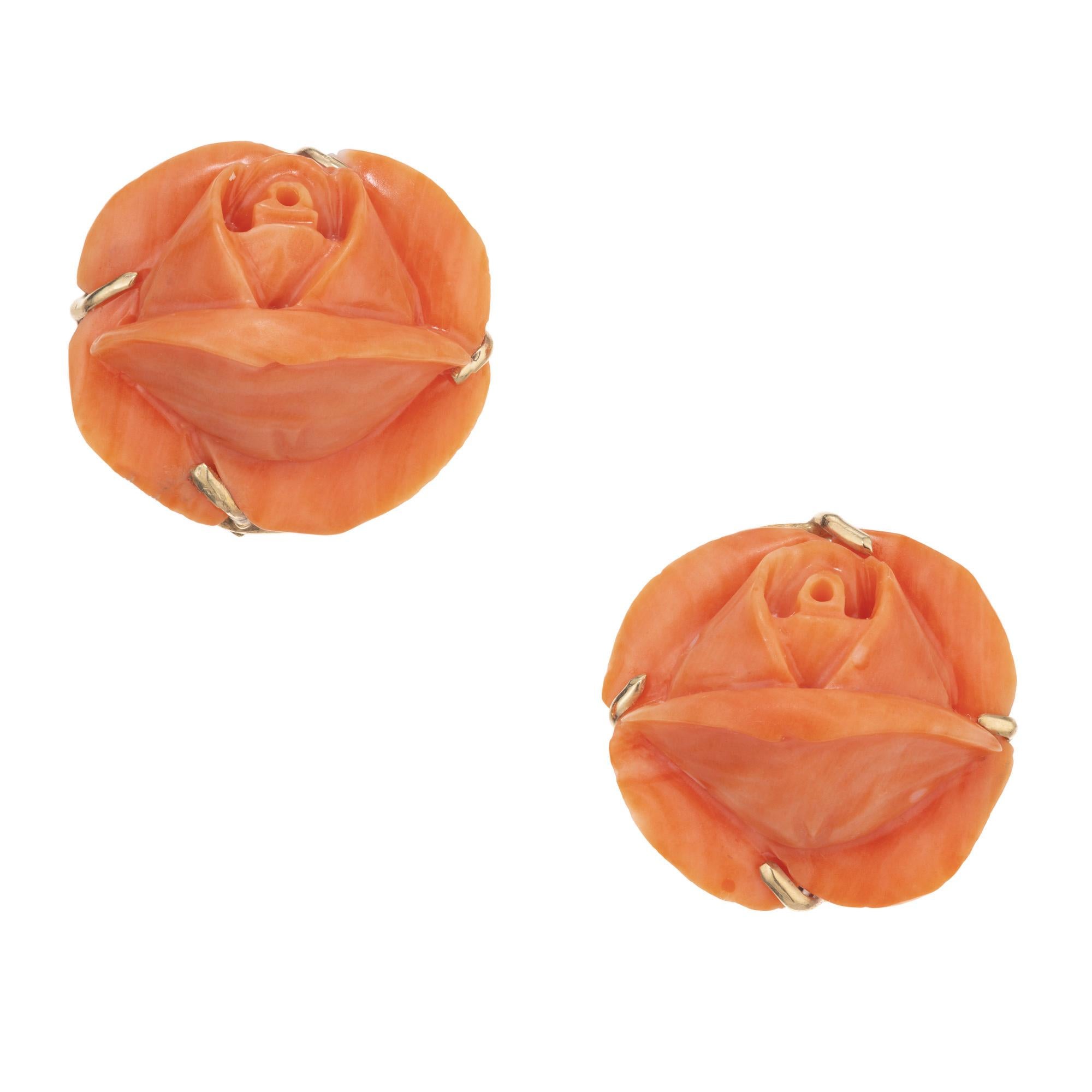 1950's mid- century vintage coral flower earrings. Two GIA certified orange/red coral in the shape of two flower buds. Both are set in 14k yellow gold, handmade four prong settings. These beautifully carved coral are GIA certified no indications of